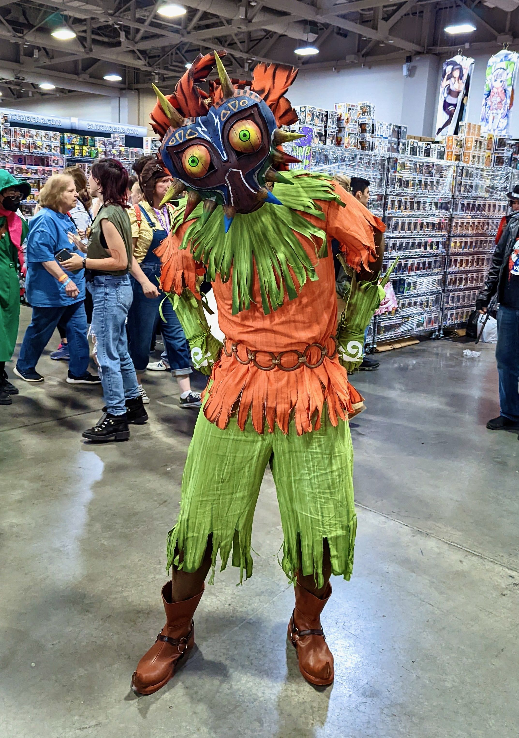 A man poses in costume at a convention.