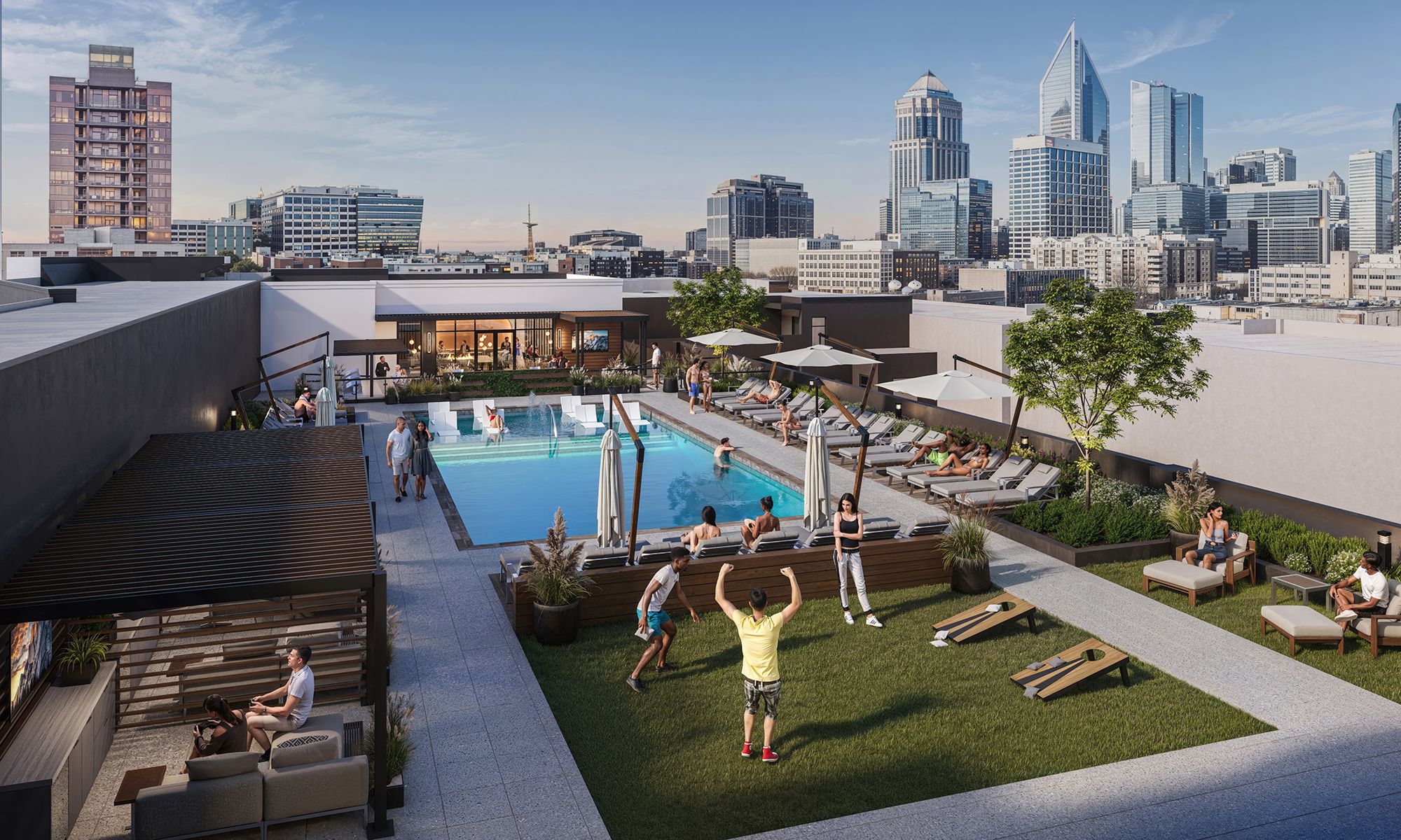 Rooftop pool area with people lounging on chairs under umbrellas, playing lawn games on green grass, and relaxing in shaded seating, with city skyline in the background under blue sky.