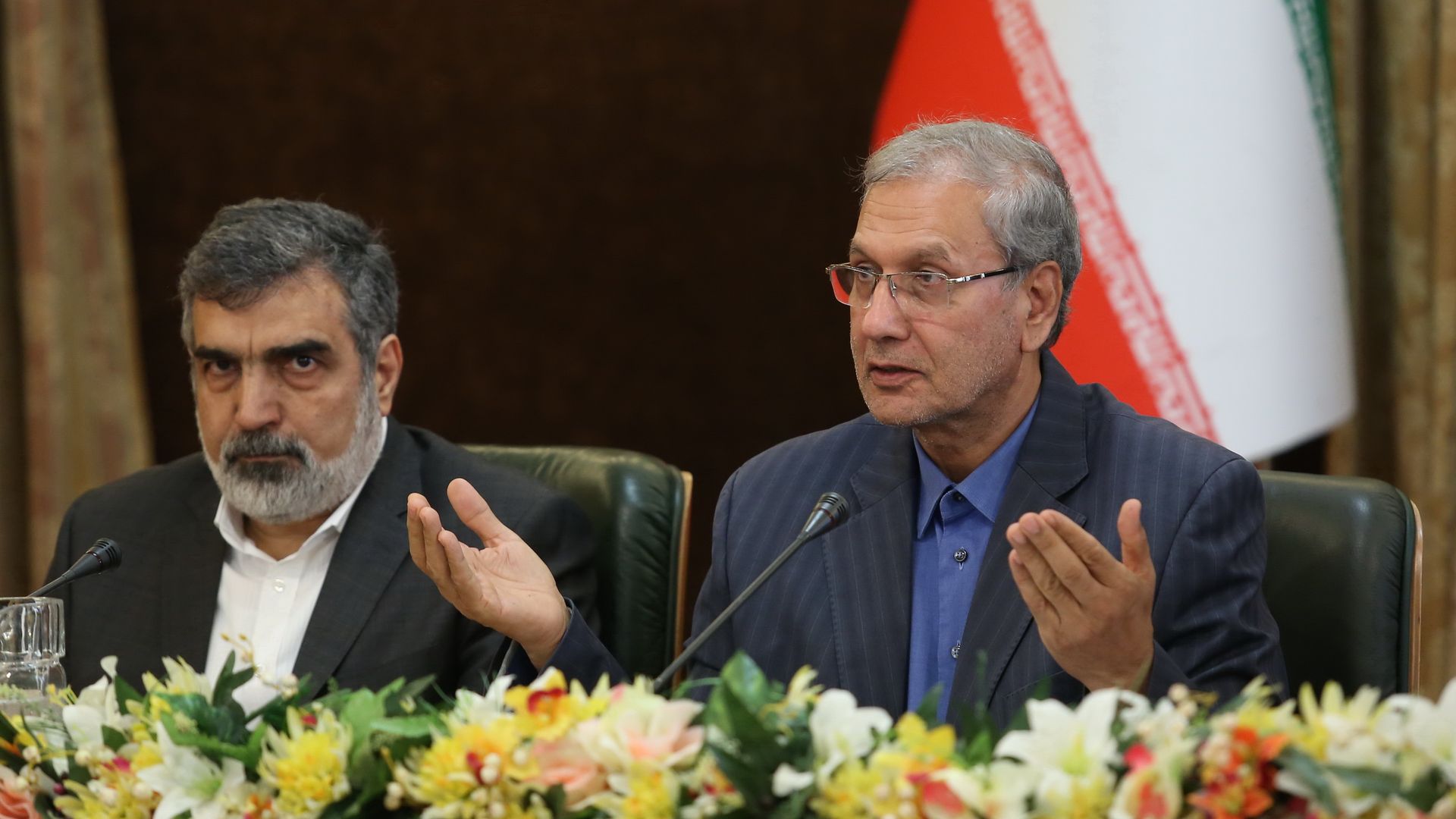 Behrouz Kamalvandi and Ali Rabiei seated while giving a press conference