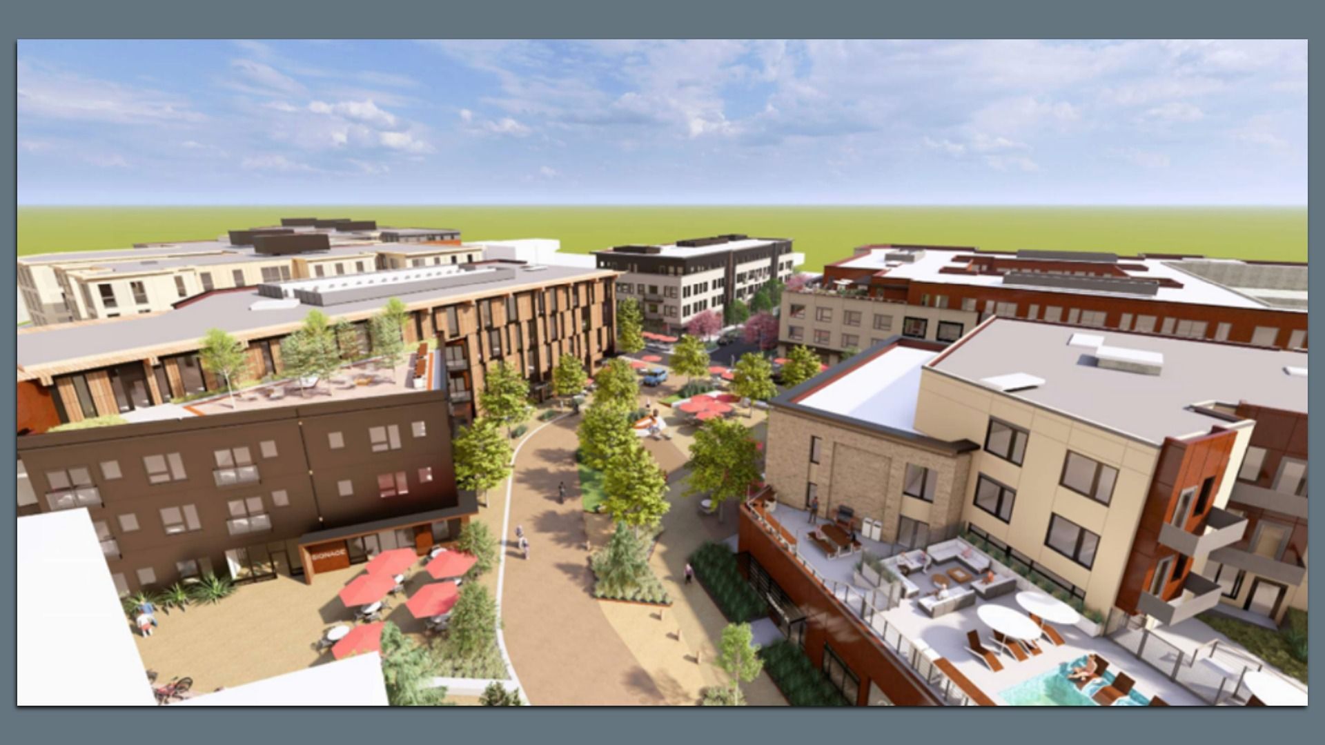 Aerial view of a modern apartment complex with multiple buildings, outdoor seating with red umbrellas, trees lining walkways, and rooftop terraces including a pool and lounge chairs.