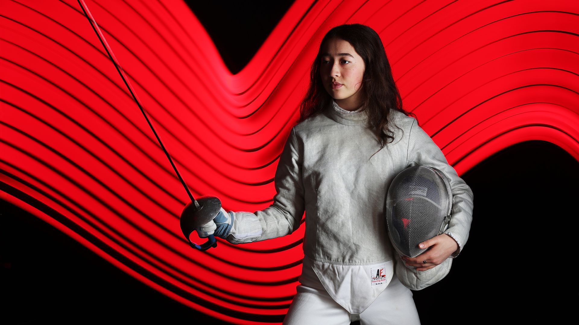 Fencer Tatiana Nazlymov stands with her fencing blade. 