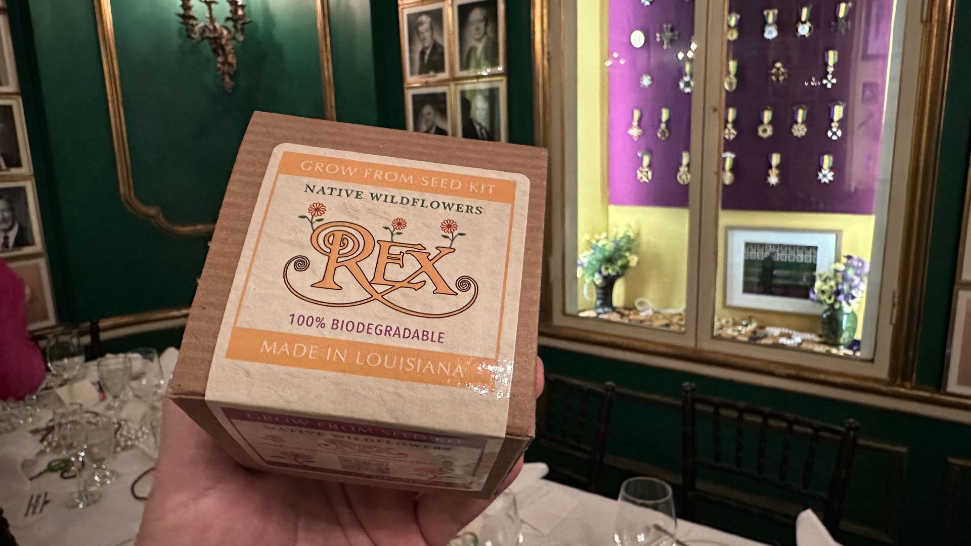 Photo shows a box of flower seeds in a box.