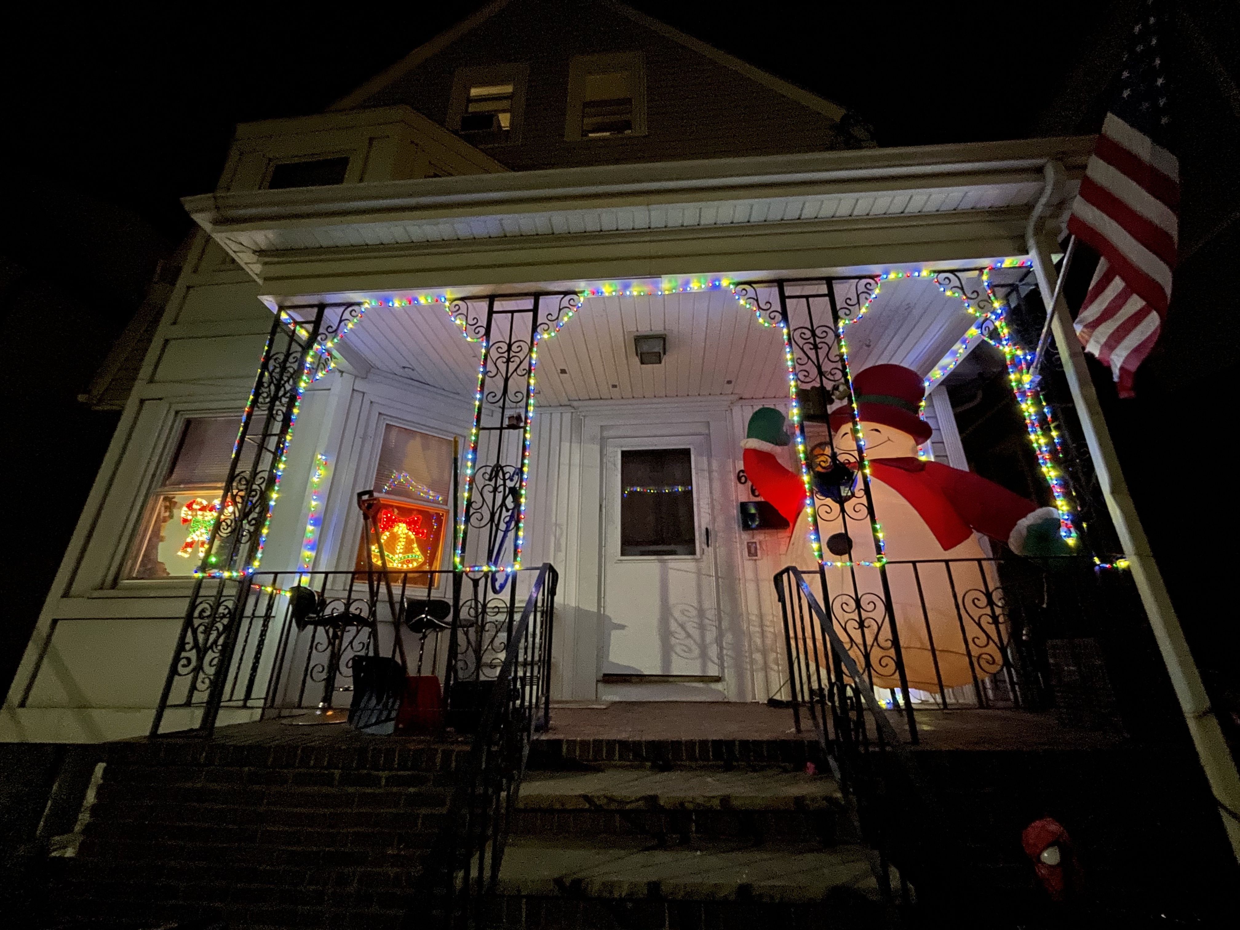 A large inflatable Santa fills part of the front porch of a house in Somerville. 