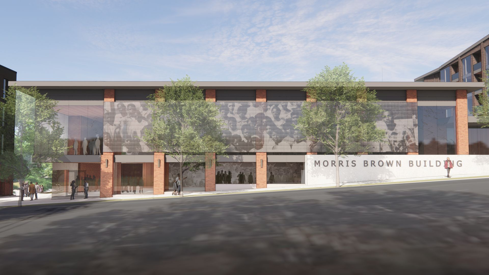 Modern Morris Brown Building with brick and glass facade, trees along sidewalk, people walking, and large black-and-white mural of people on upper walls under a partly cloudy sky.