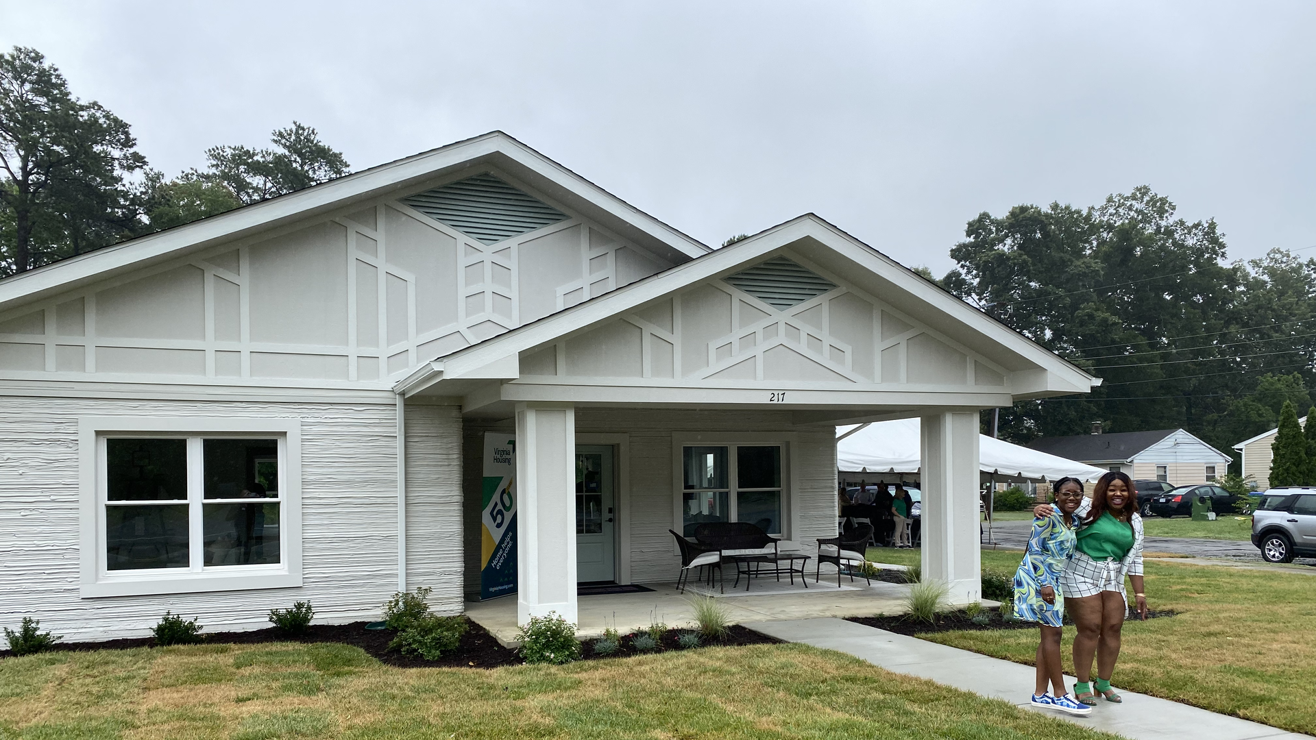 A white house that's been 3-day printed on the outside with a big porch.