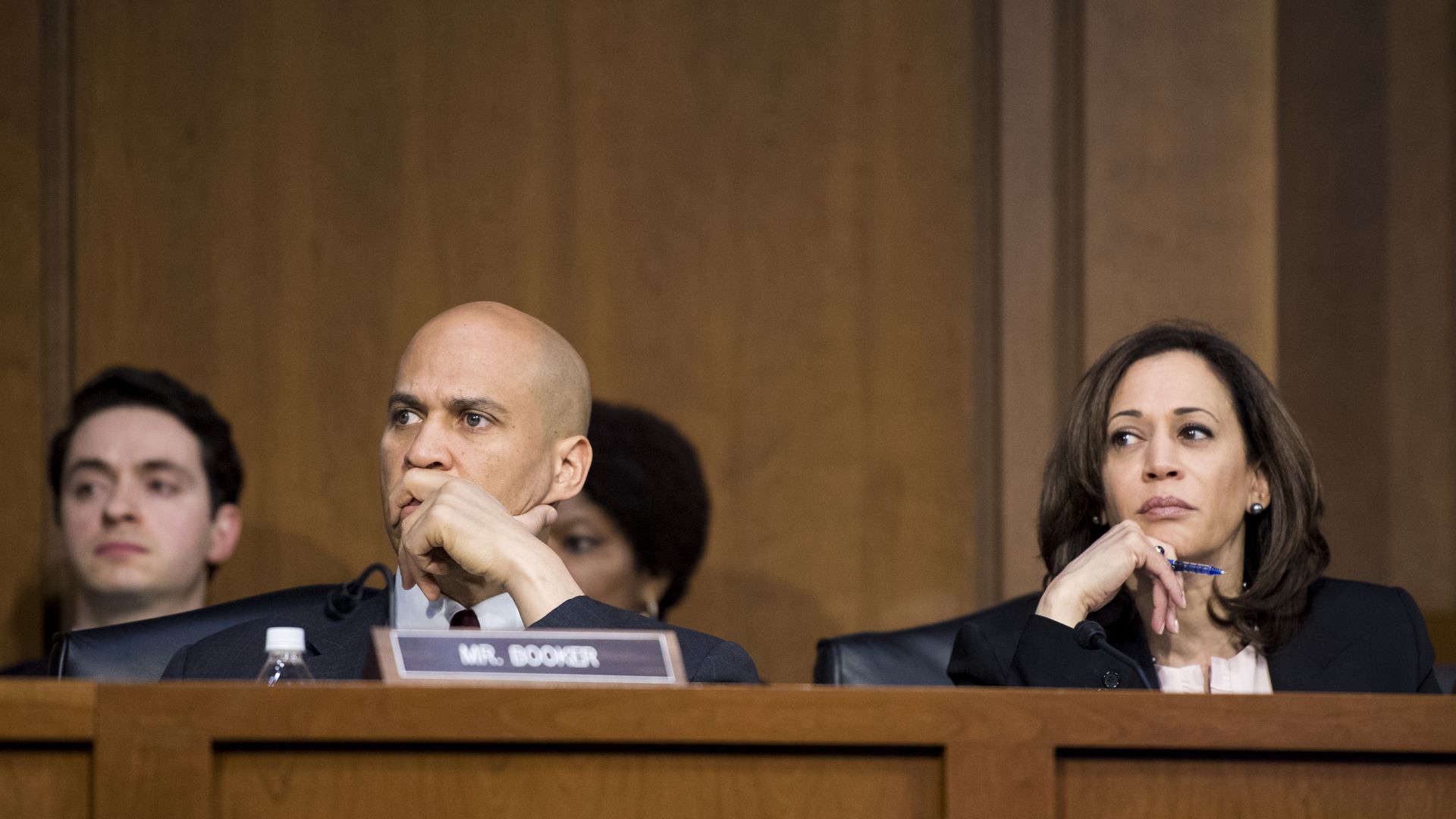 Senators Booker and Harris look stern.
