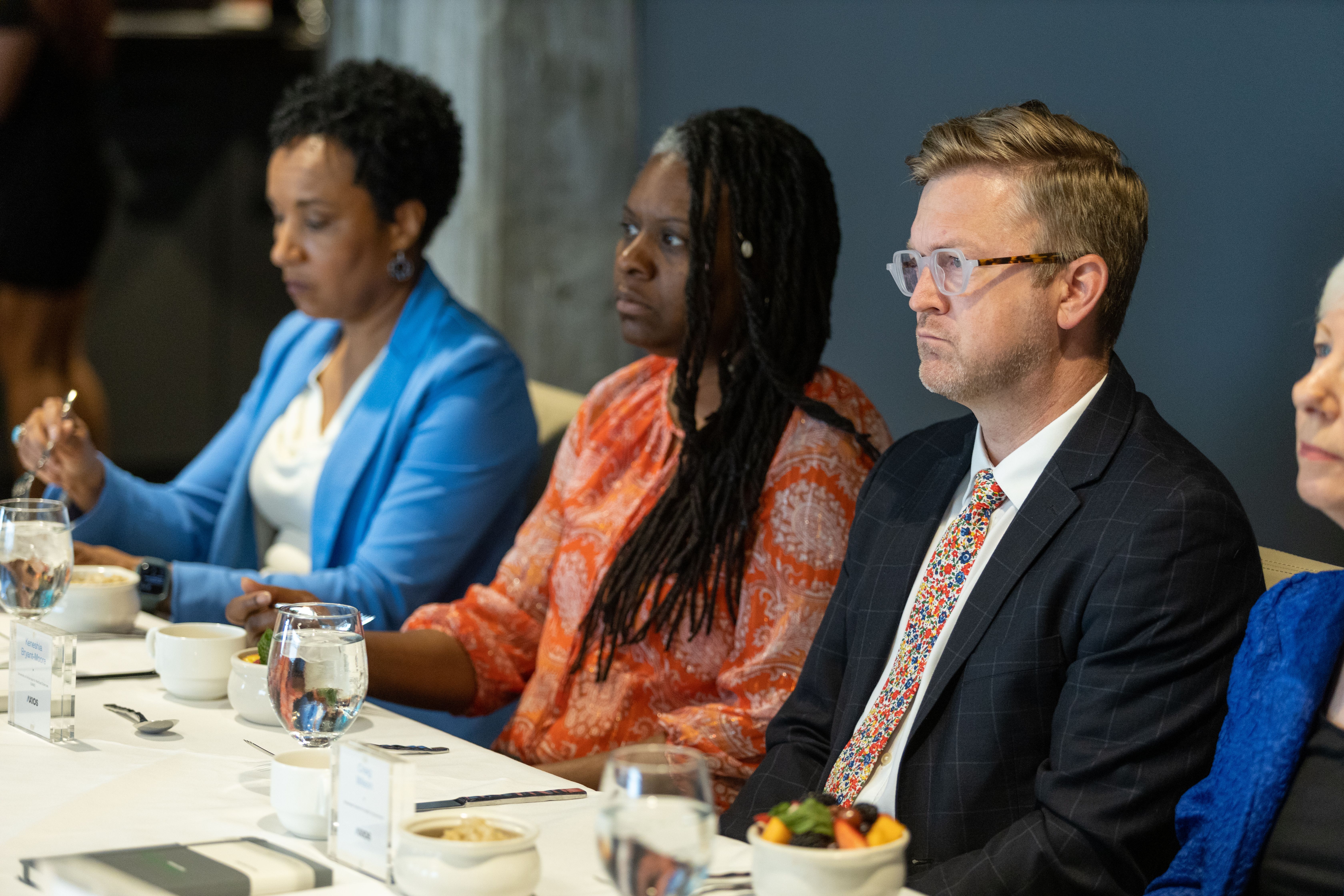 Dr. Keneshia Bryant-Moore sits at the Axios table between Marico Howe, left, and Craig Wilson. 