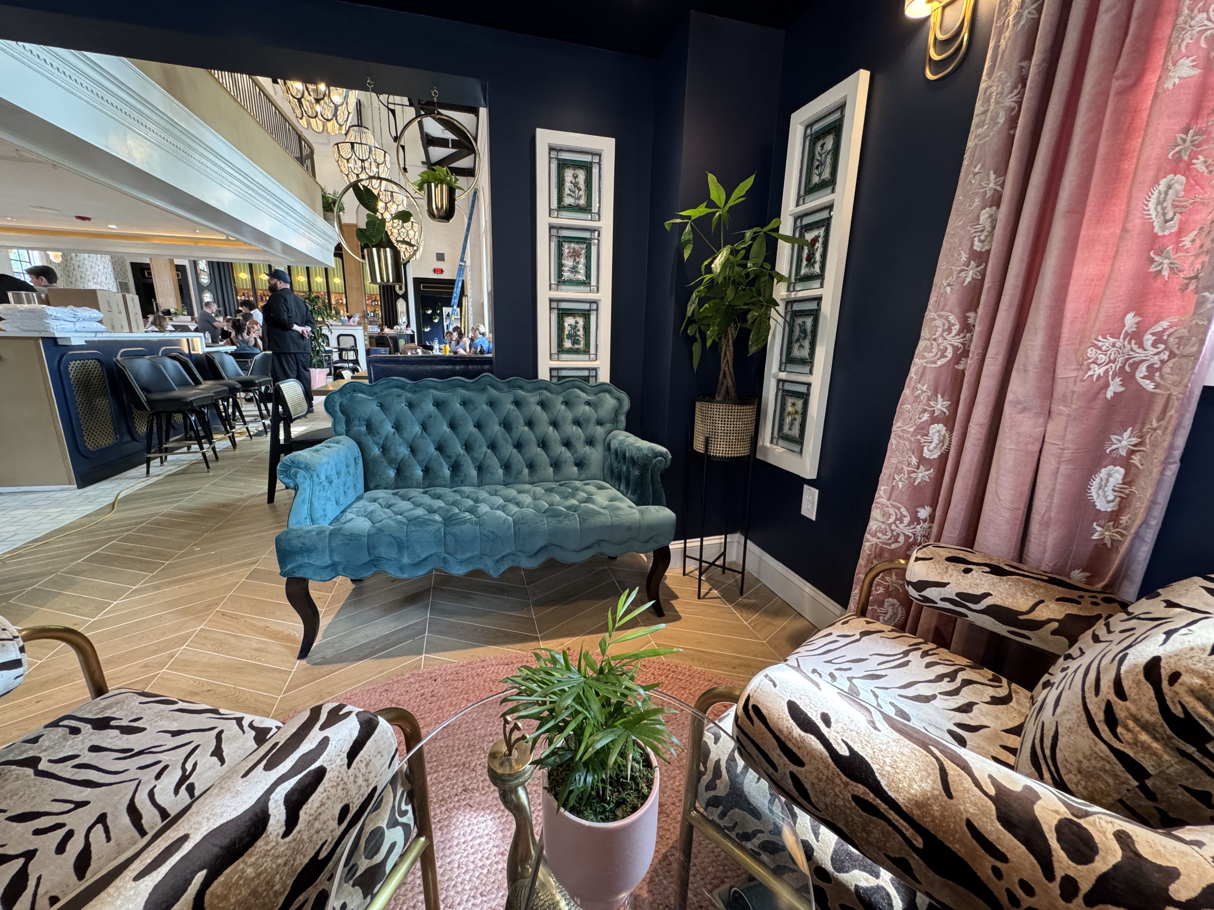 inside a restaurant waiting room with a couch and two chairs