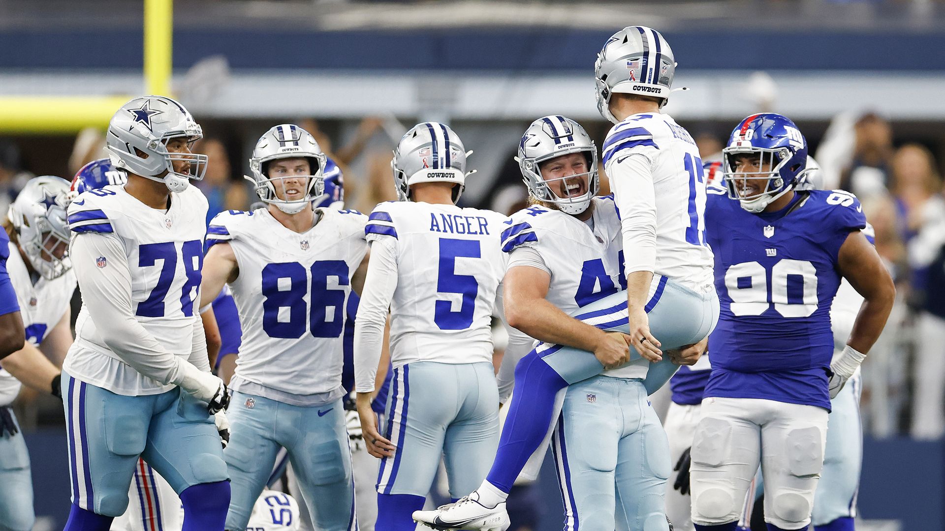 Dallas Cowboys players celebrate on the field after Brandon Aubrey #17 kicked a field goal