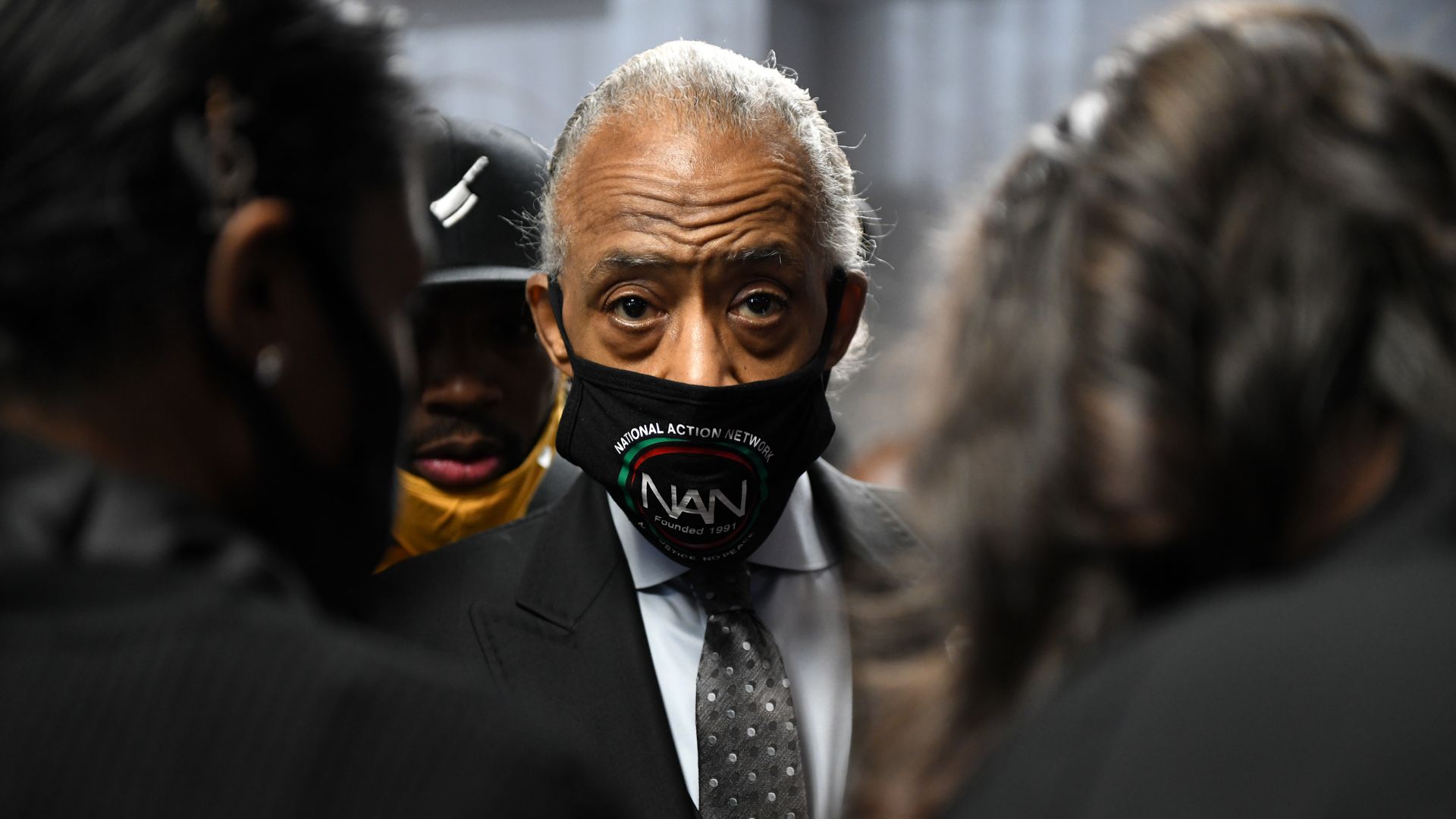 Photo of Al Sharpton wearing a mask and staring right at the camera