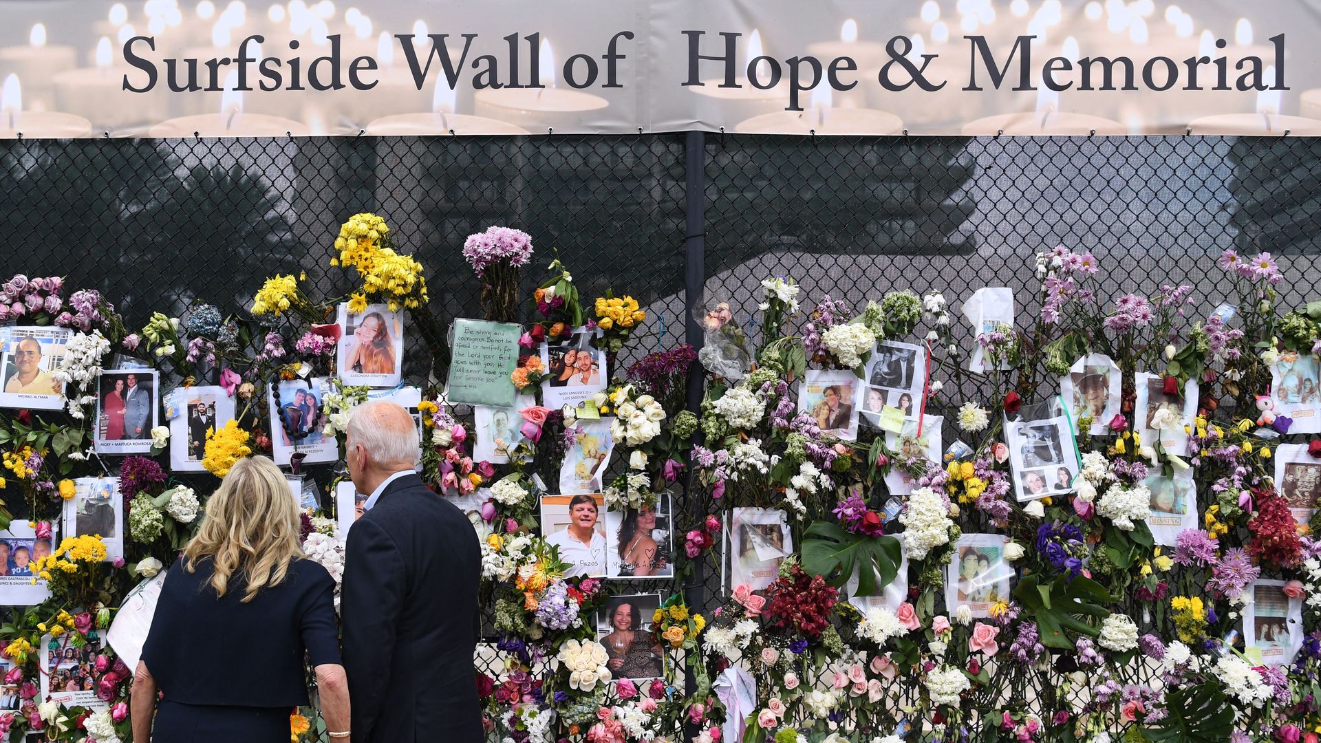 Joe and Jill Biden visit a photo wall, the 'Surfside Wall of Hope & Memorial', near the partially collapsed condo building 