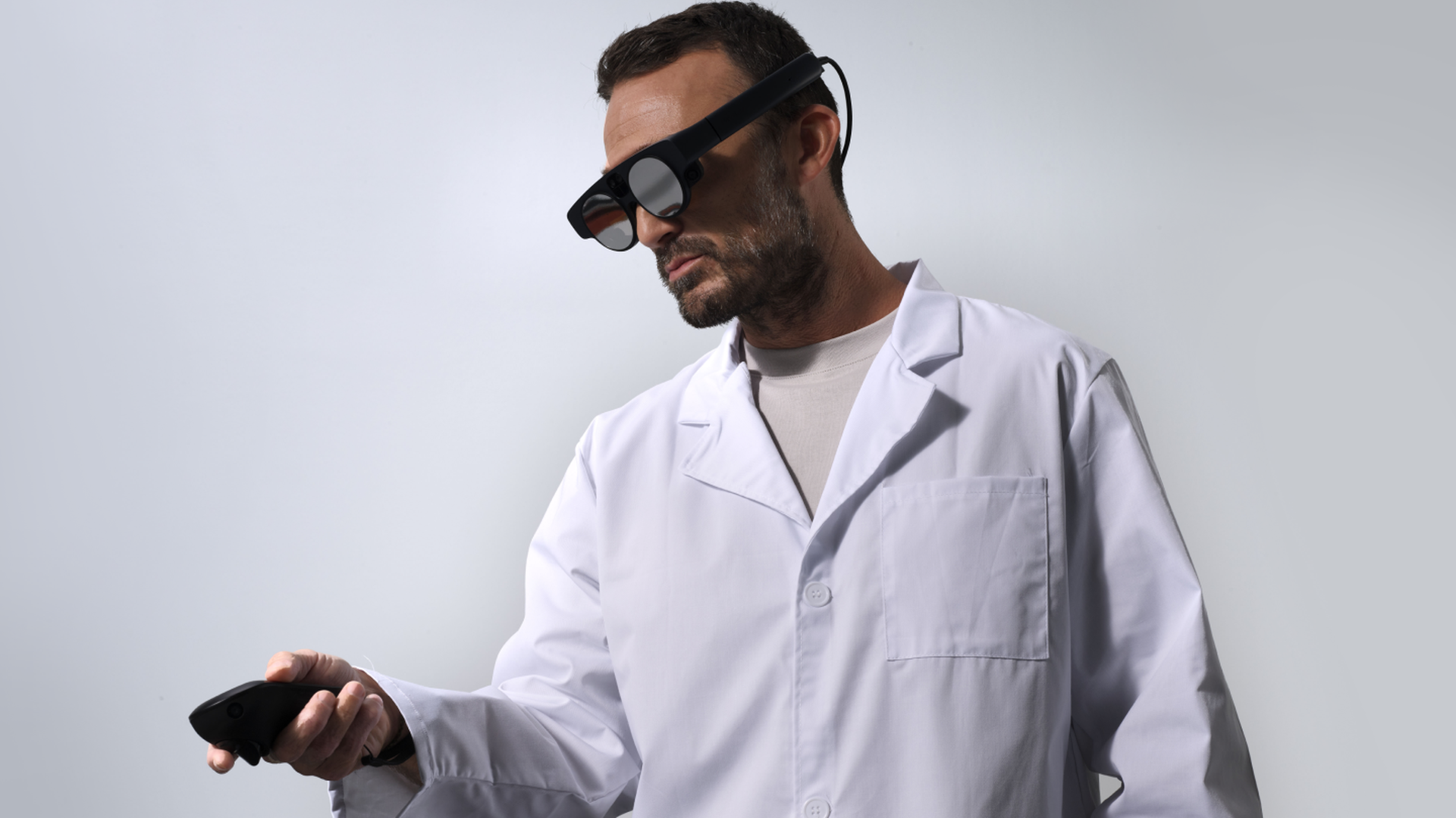 A man in a medical shirt wearing a Magic Leap 2 headset