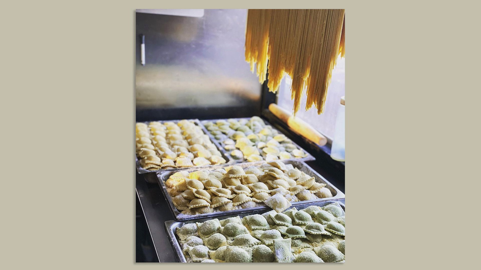 A photo of pasta on trays and hanging.