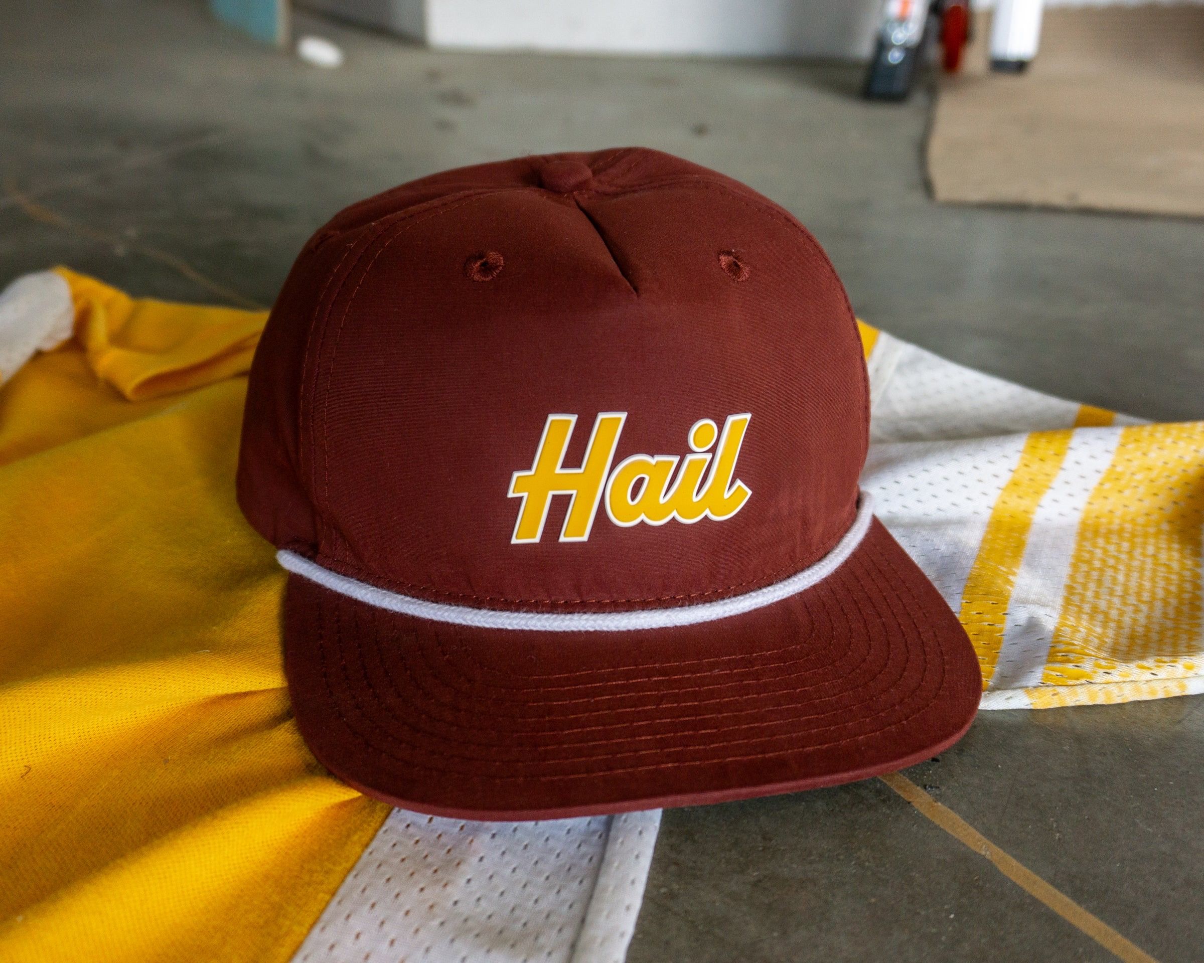 A photo of a red hat reading "Hail" in yellow letters.