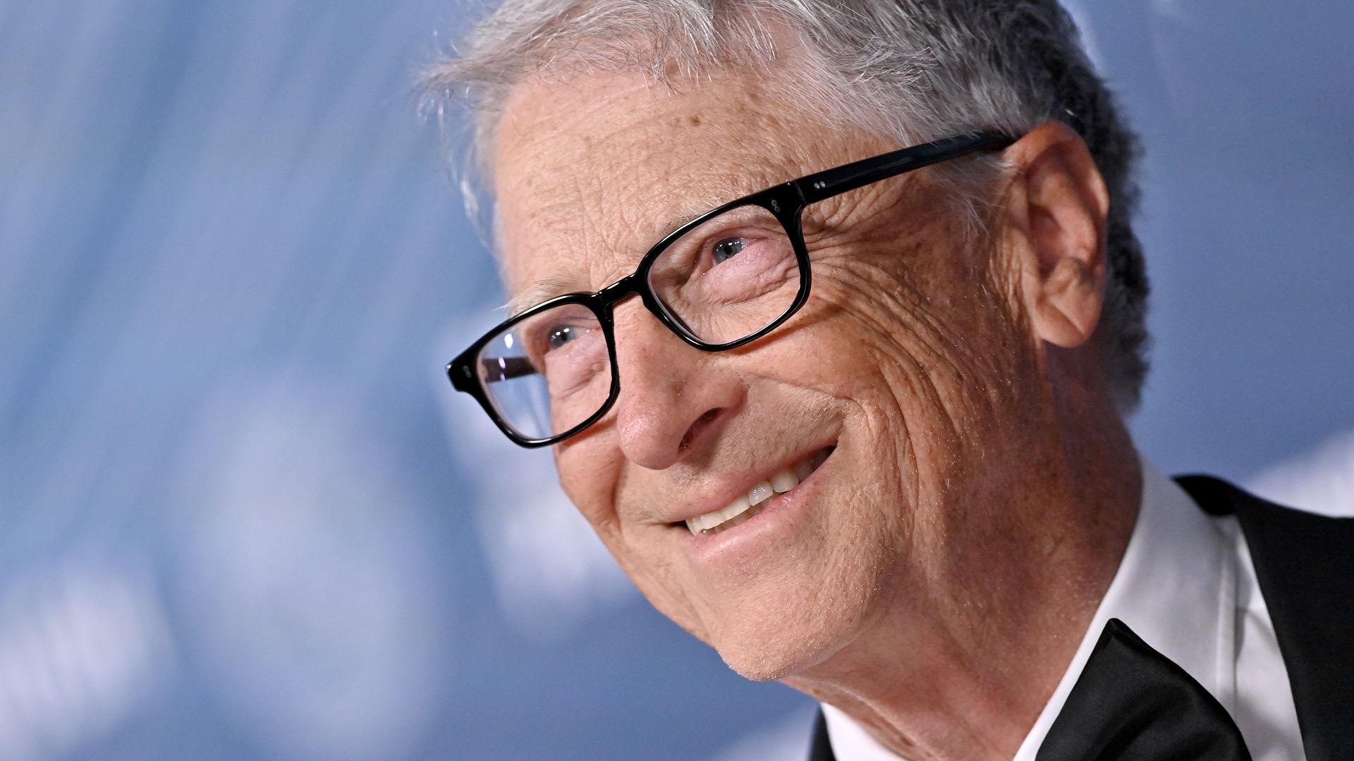 Bill Gates smiles as he attends an event.