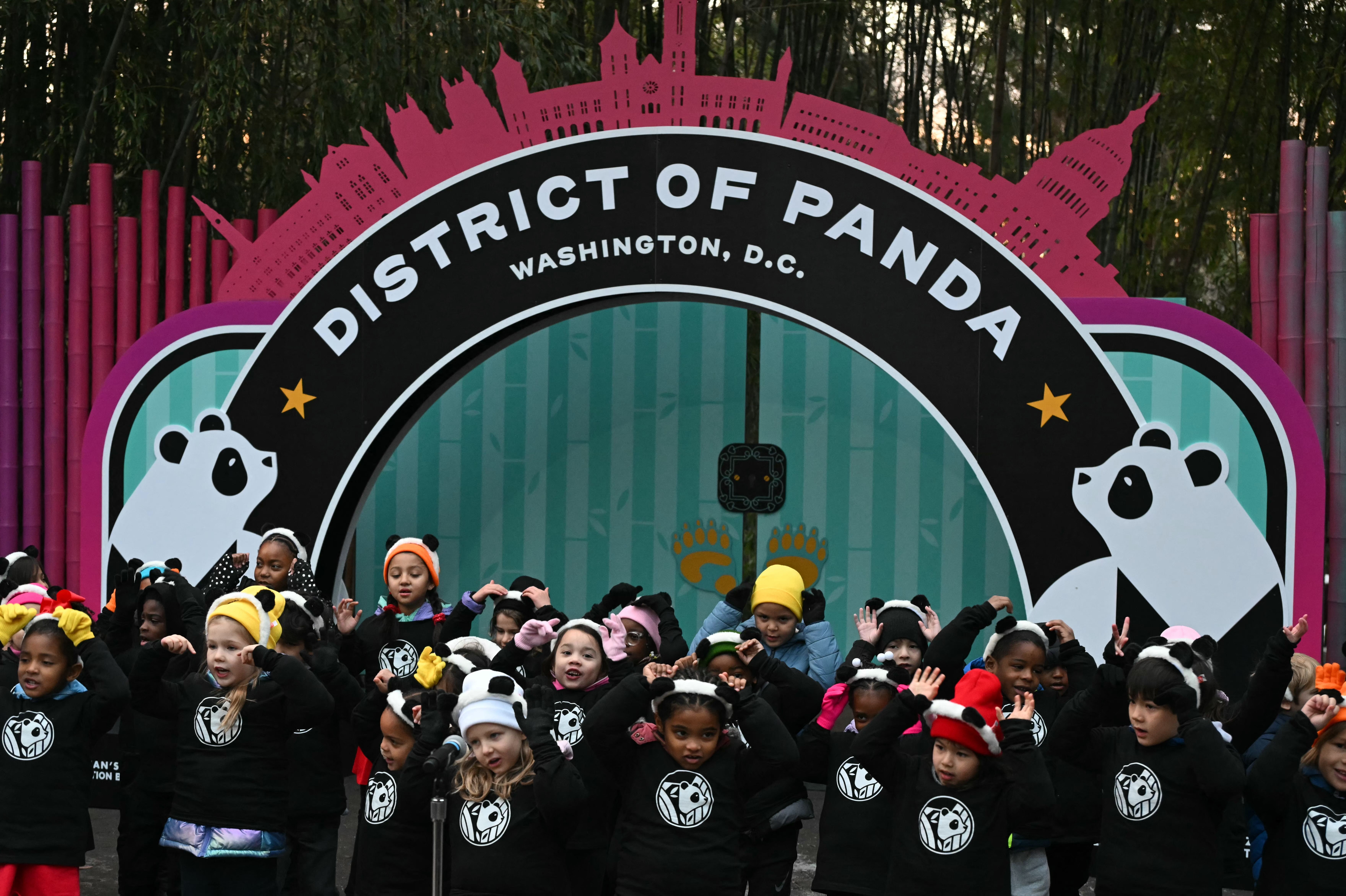 Children from the Yu Ying Public Charter School sing at the Smithsonian's National Zoo in Washington, DC, before Giant pandas Bao Li and Qing Bao make their public debut on January 24, 2025. The pandas arrived at the zoo on October 15, 2024, in the latest chapter in China's campaign of international
