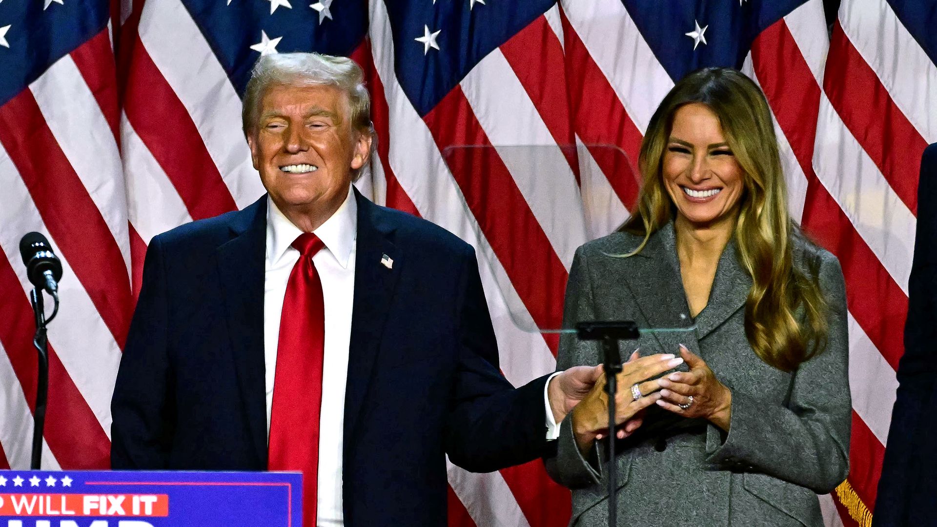 President-elect Trump and former first lady Melania Trump smile after speaking during an election night event at the West Palm Beach Convention Center in West Palm Beach, Florida, early on November 6, 2024. 