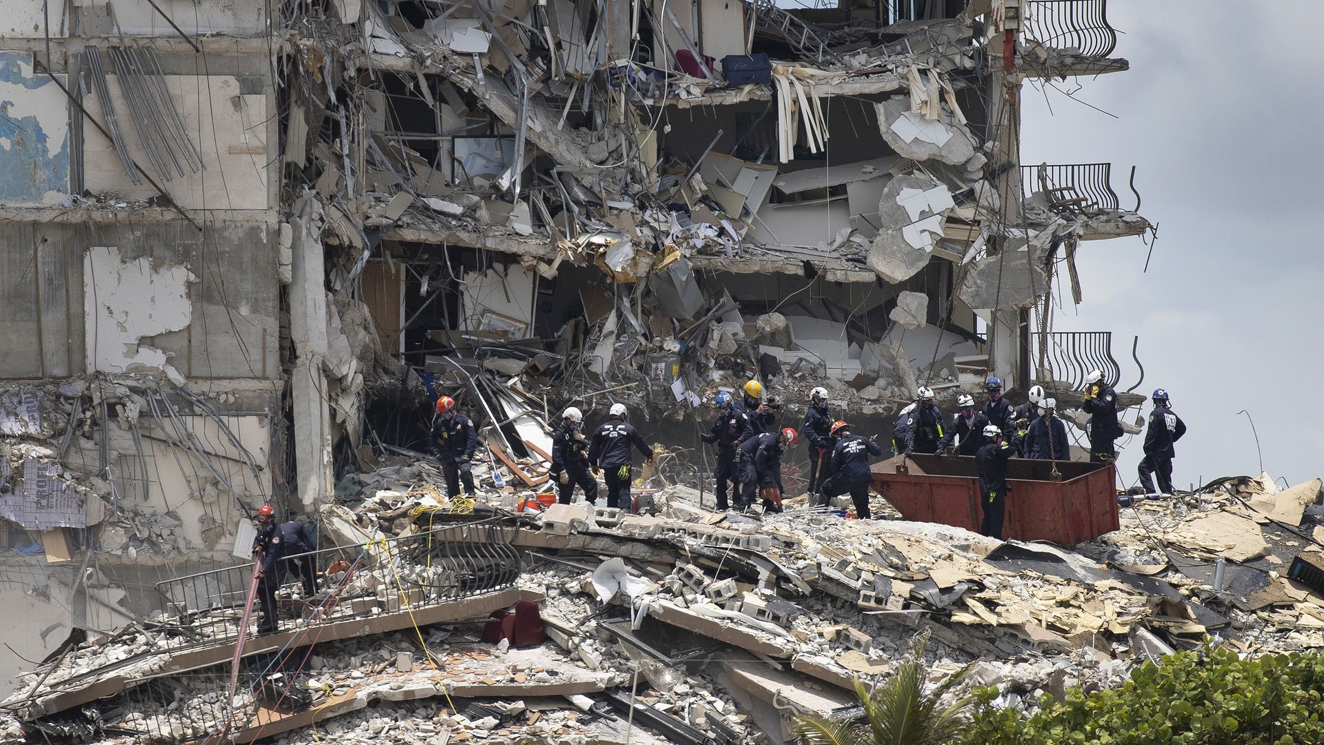Members of the South Florida Urban Search and Rescue team look for possible survivors in the partially collapsed 12-story Champlain Towers South condo building on June 26, 2021 in Surfside, Florida.
