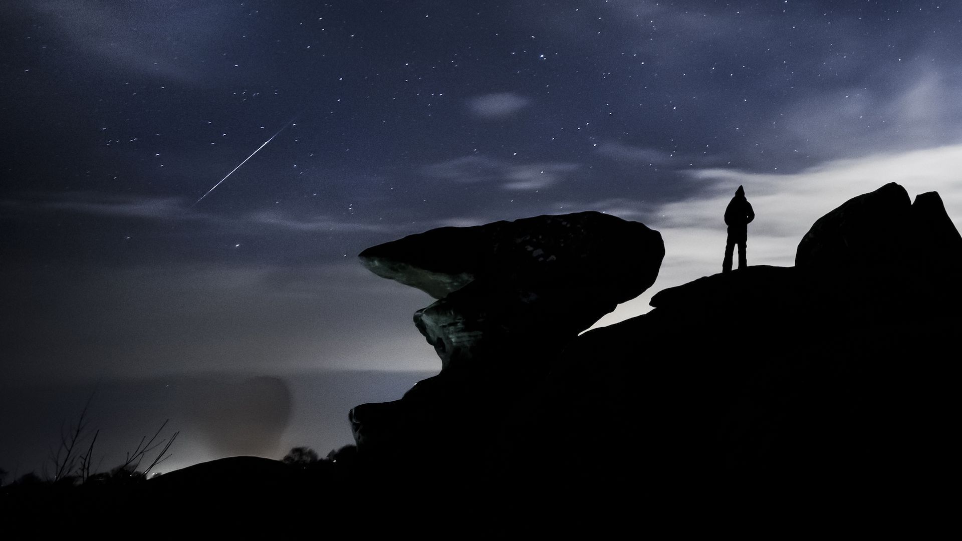 Photo of a person watching a Geminid meteor shower