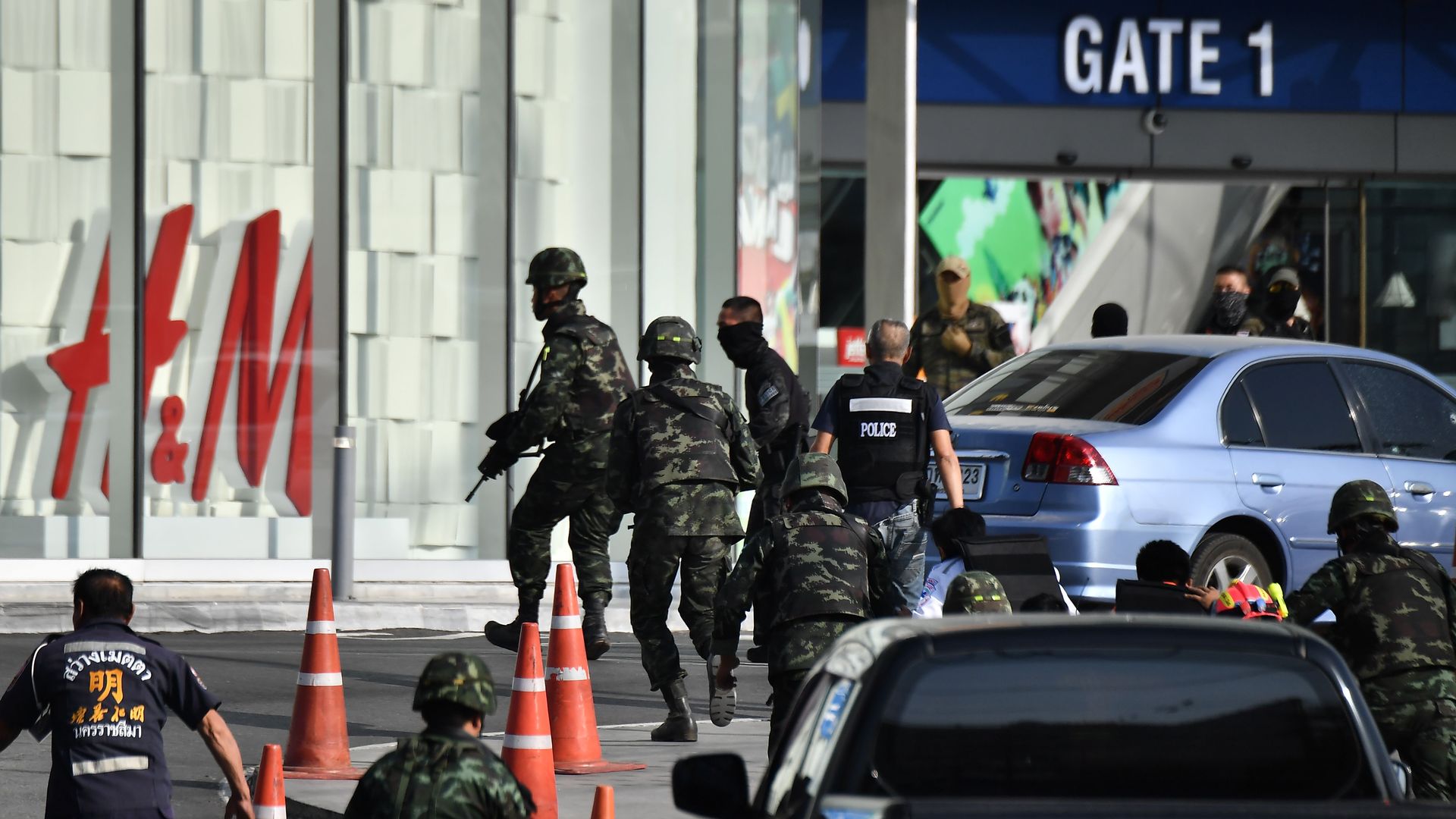 Security personnel prepare to enter the Terminal 21 mall, where a mass shooting took place