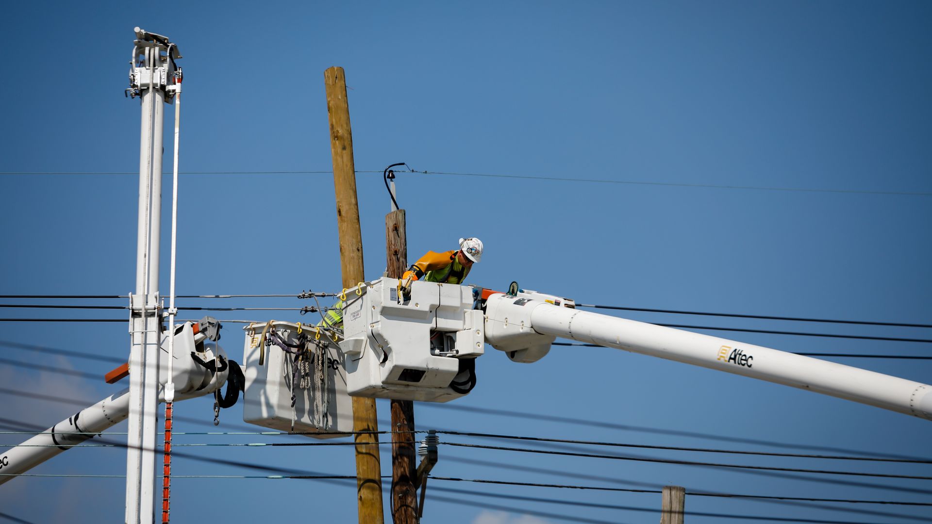 A worker repairs a utility poles during a power outage after Hurricane Ida in New Orleans, Louisiana, U.S., on Friday, Sept. 3, 2021