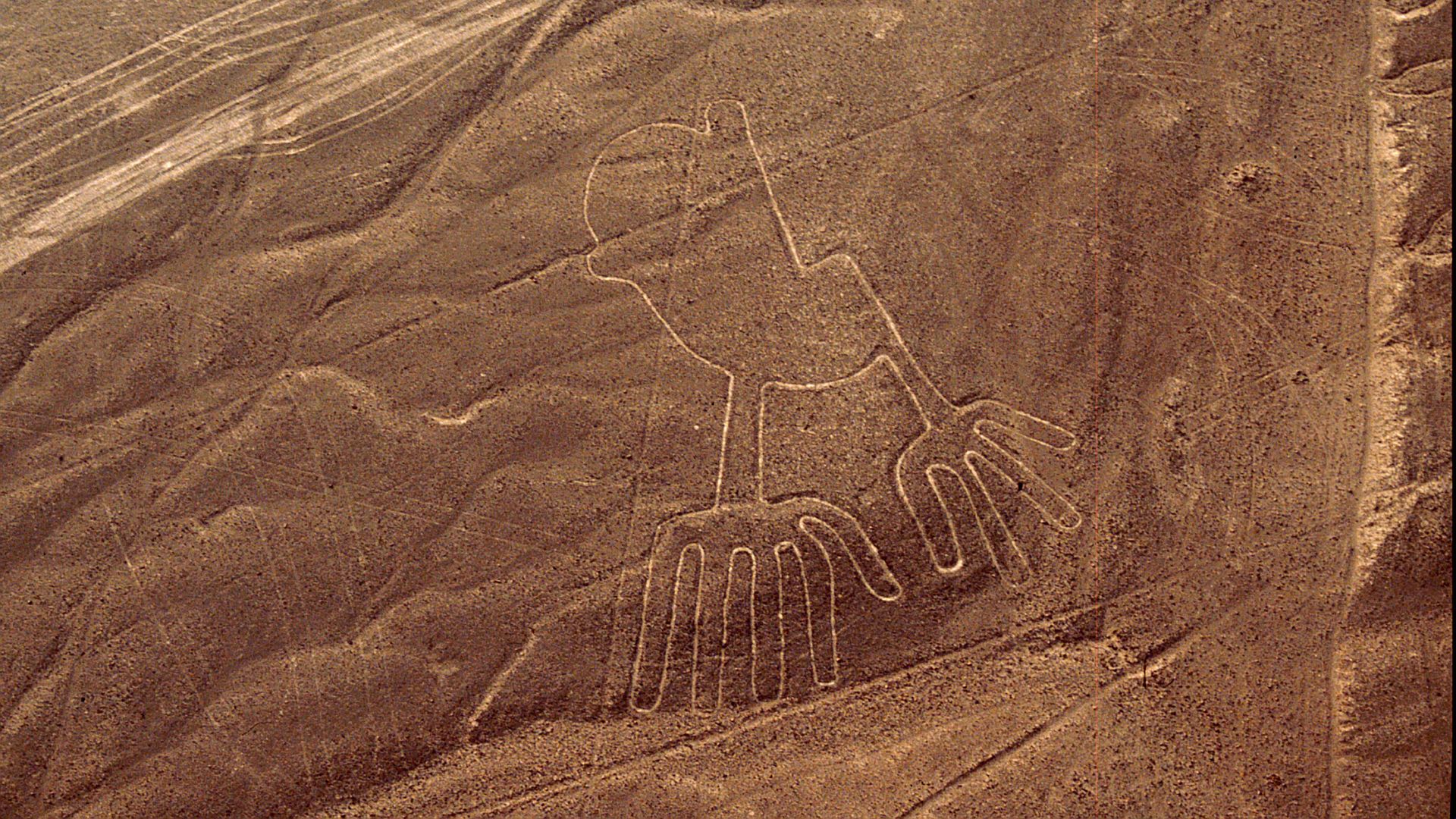 A glyph of an animal shape with large hands