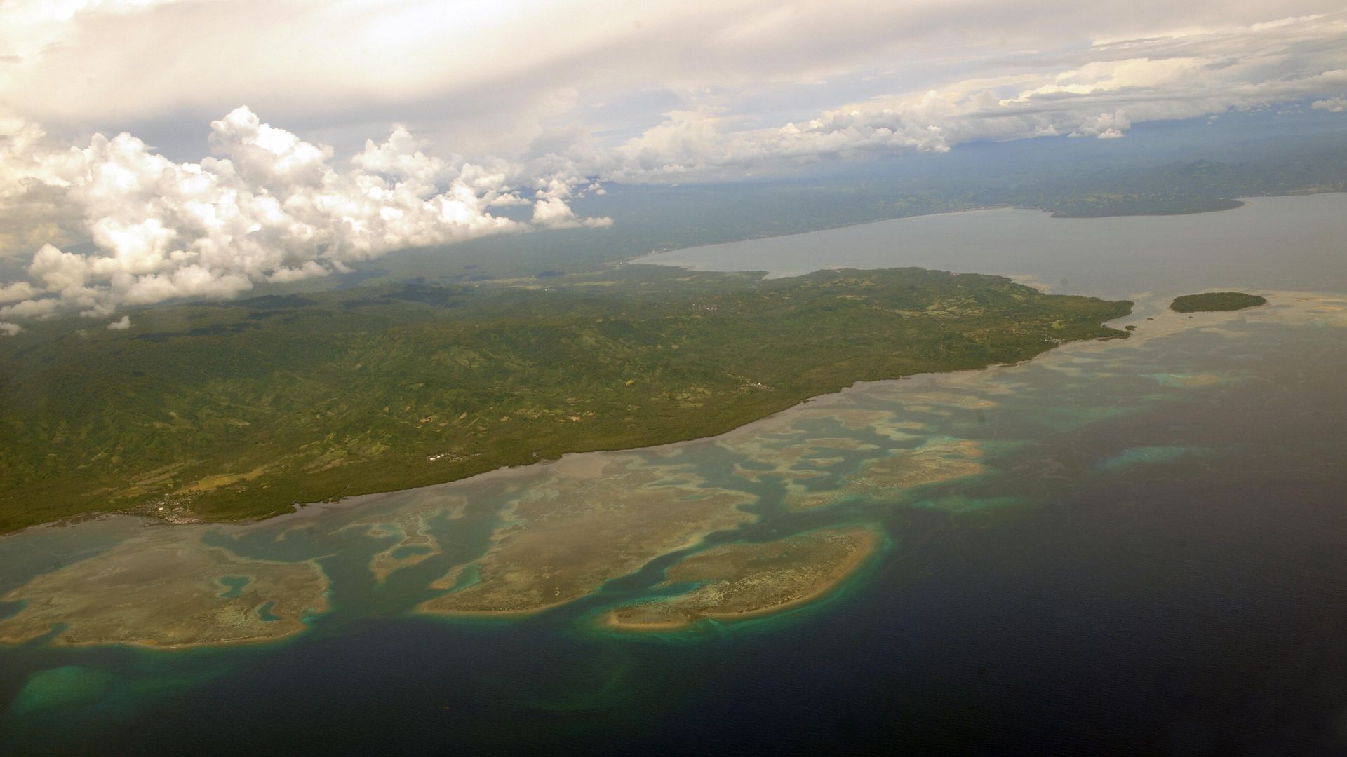 The coast of northern Sulawesi is seen from a plane approaching the capital city of Manado 