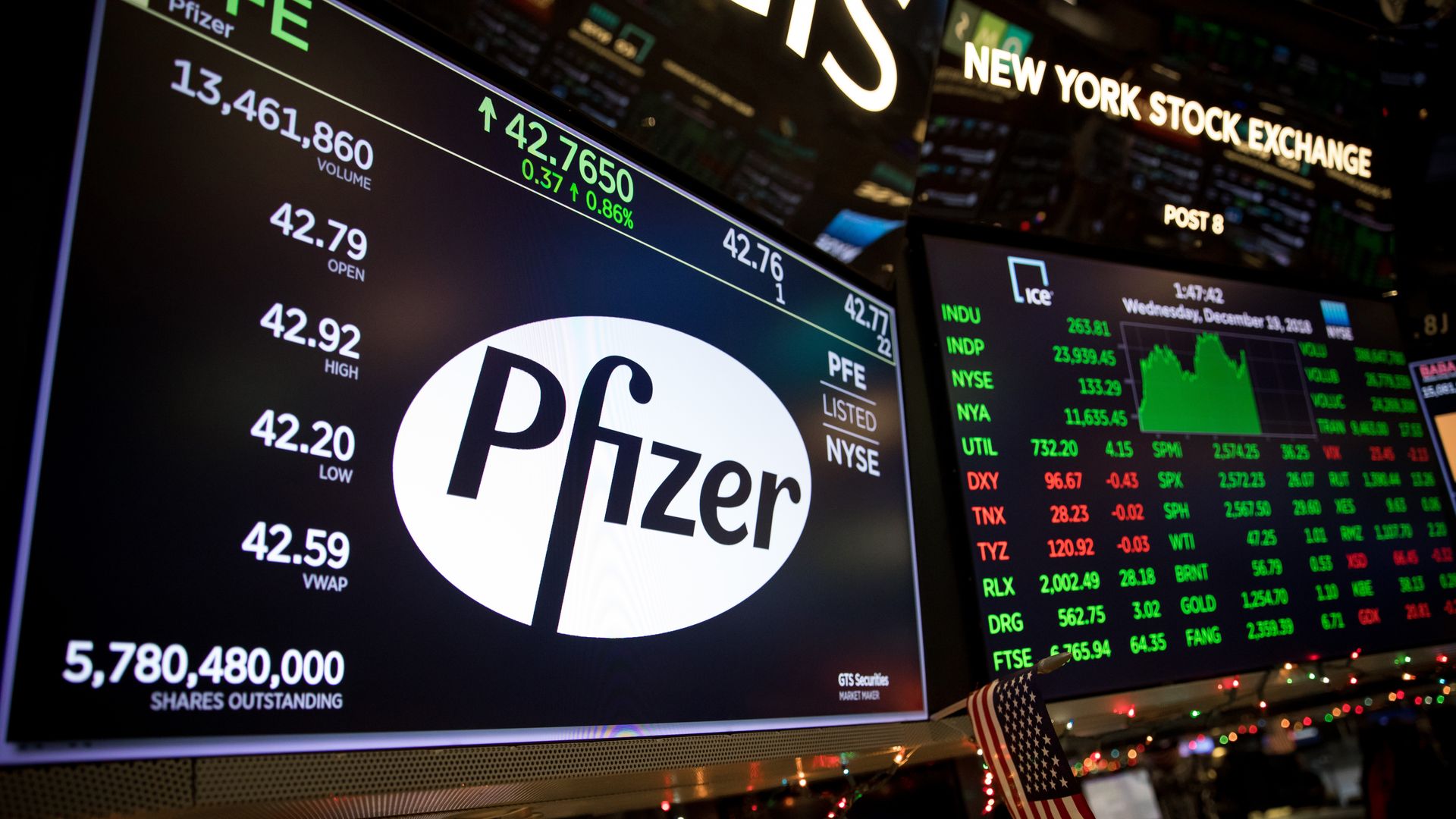 A white Pfizer logo on a computer screen on the Wall Street trading floor.