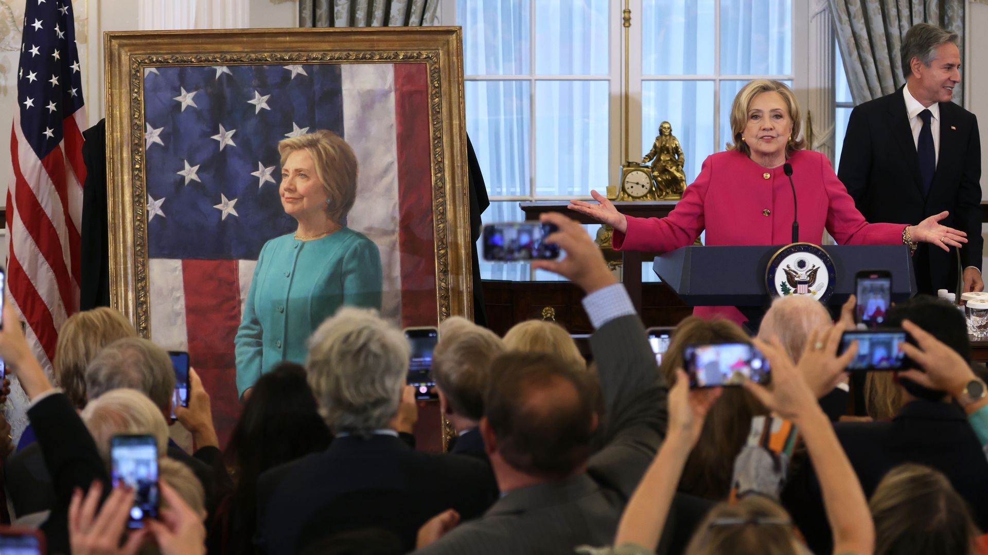 Former U.S. Secretary of State Hillary Clinton speaks as Secretary of State Antony Blinken listens during an unveiling of her portrait at the State Department on September 26, 2023 in Washington, DC. 