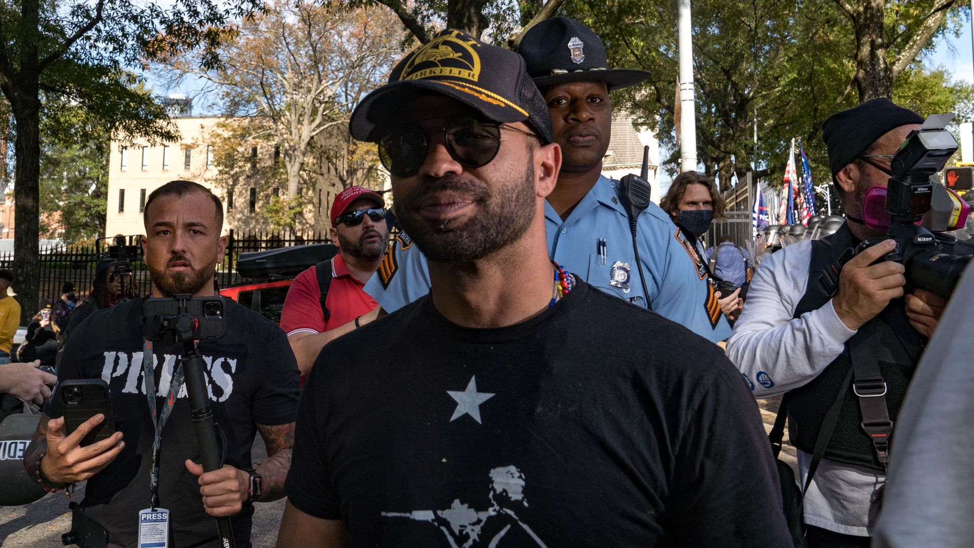 Enrique Tarrio, head of the Proud Boys, is escorted out of the areaoutside of the Georgia State Capital building on November 21, 2020 in Atlanta, Georgia.