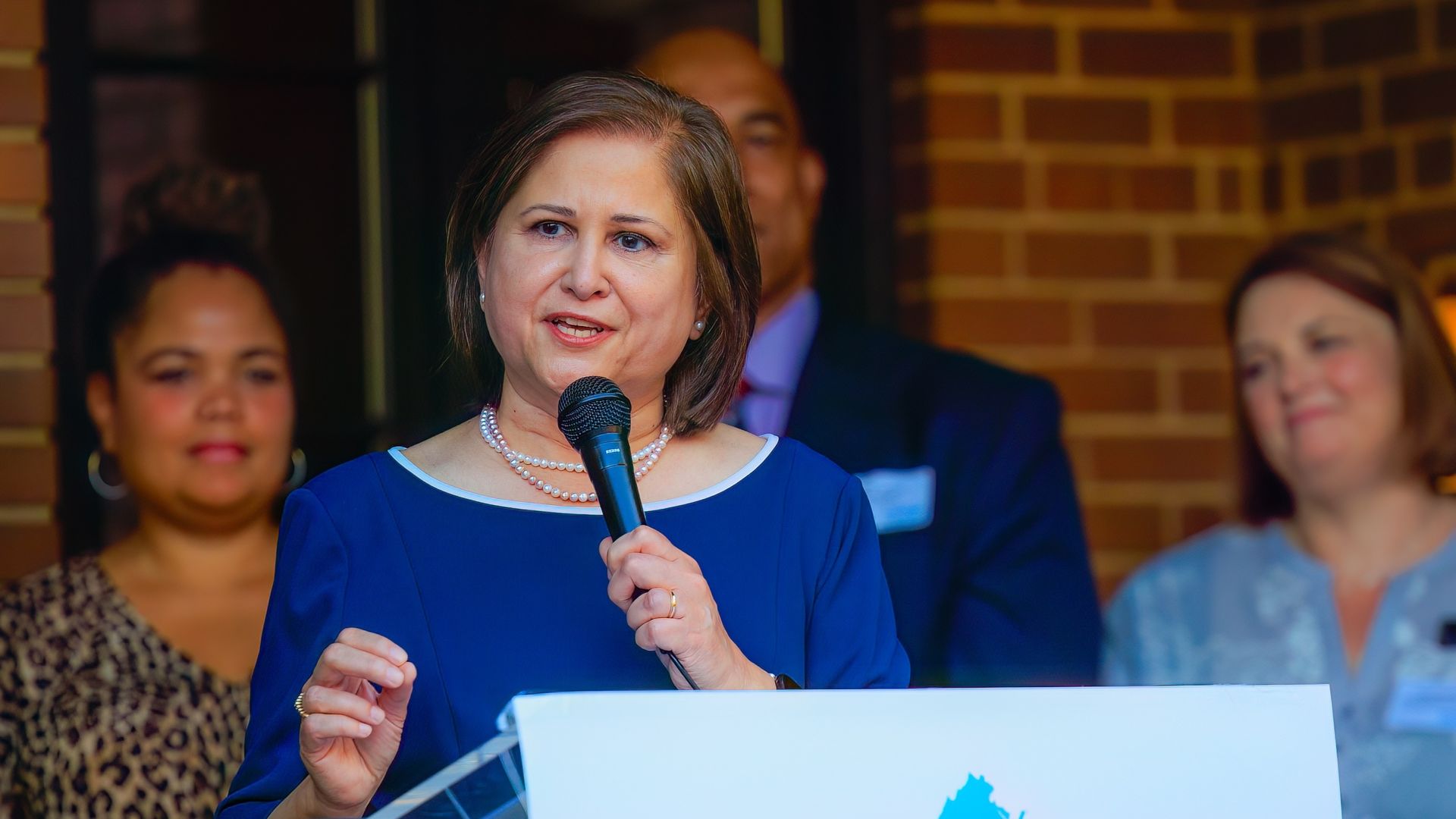 a pic of ghazala hashmi speaking into a microphone