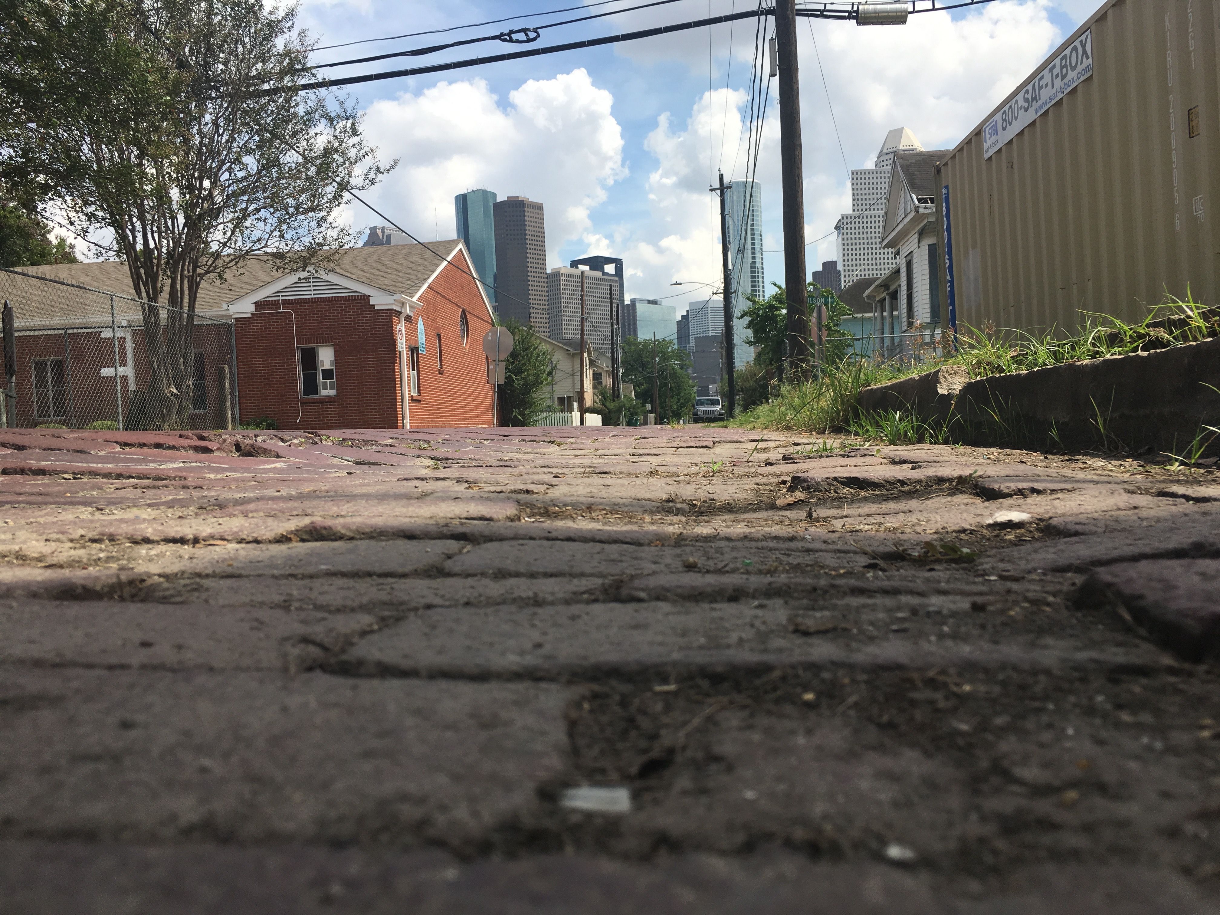 Bricks laid by emancipated enslaved people at Freedmen’s Town in Houston are shown with the city's modern skyline. 