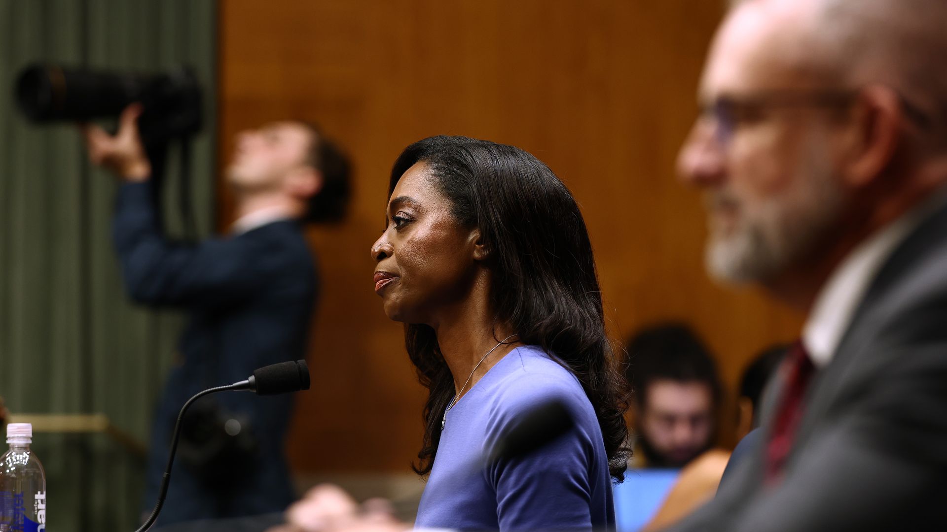 Dr. Erica Schwartz sits in front of a microphone in a side profile, wearing a purple top.