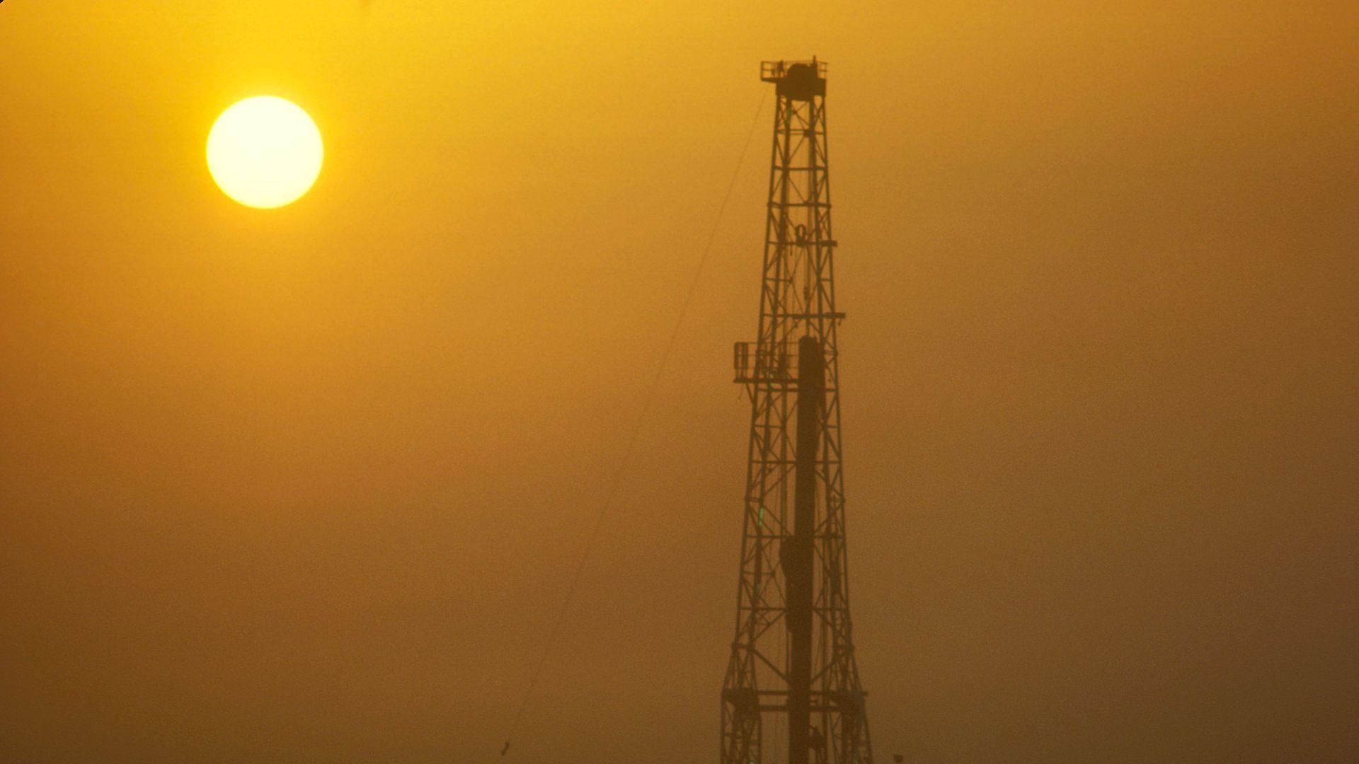 An onshore oil rig at sunset. 