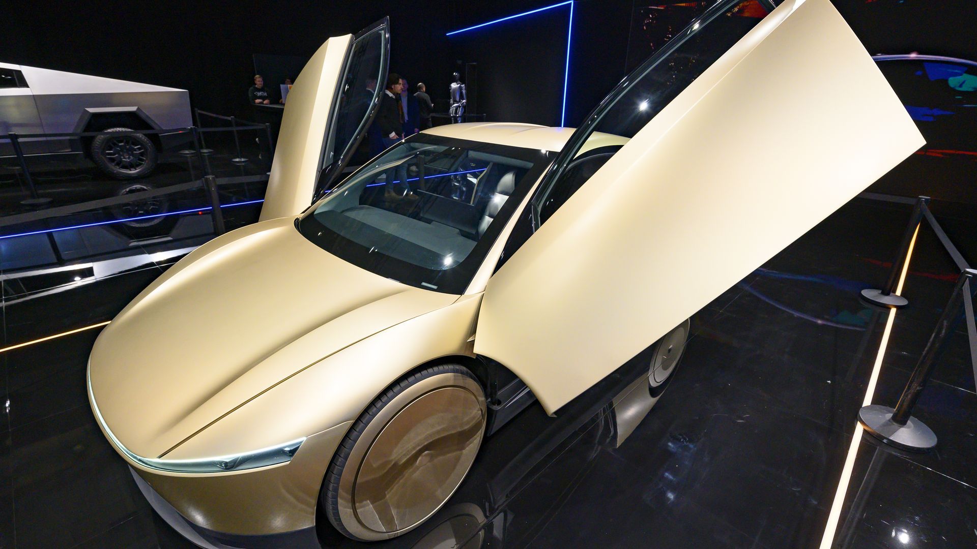 A Tesla Cybercab with its doors open in a showroom.