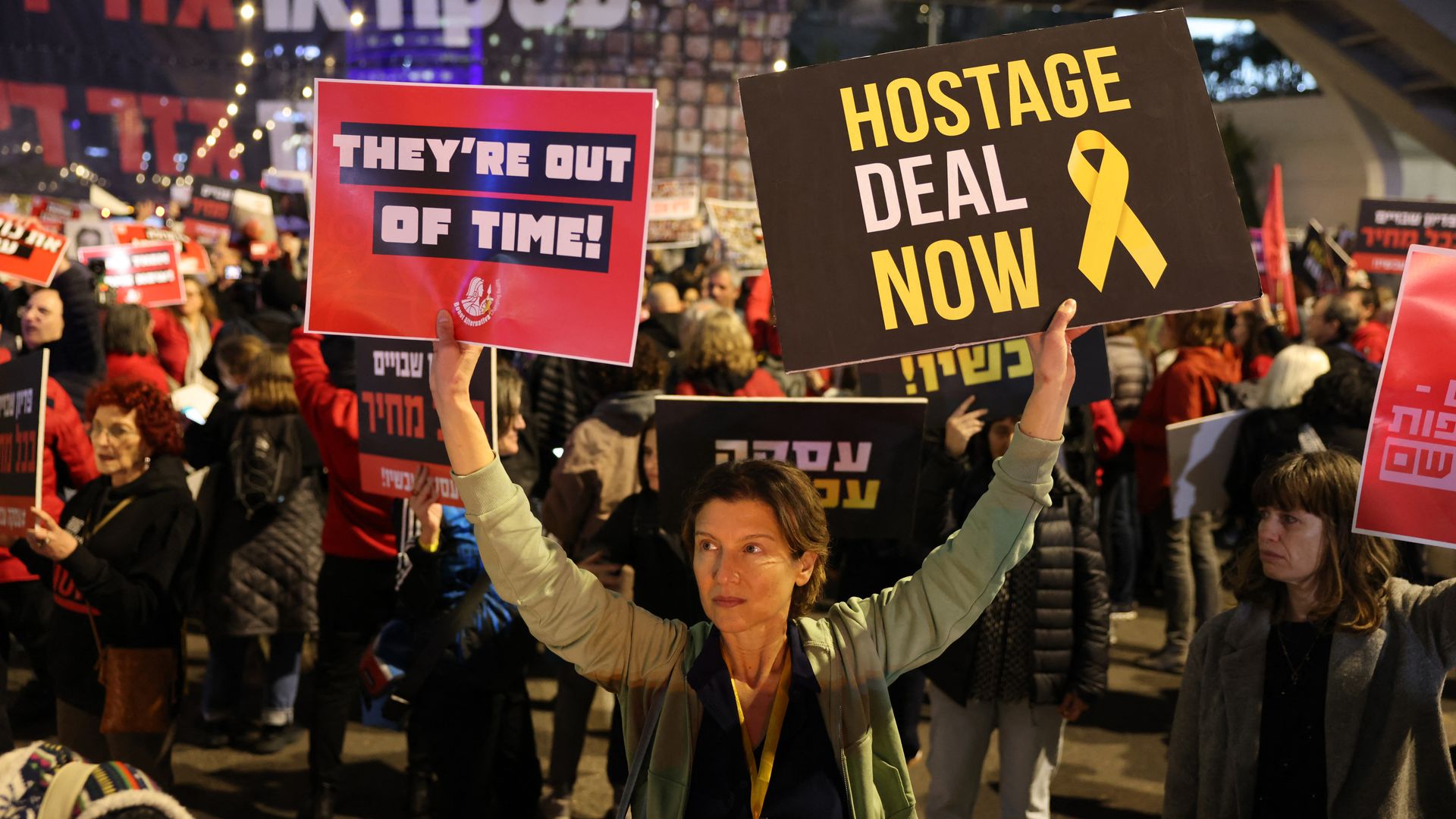 Relatives and supporters lift placards bearing portraits of Israeli hostages held in Gaza since the October 7