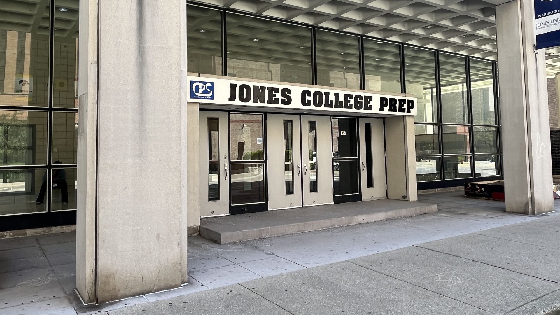 Photo of the front of a high school that says "Jones College Prep"