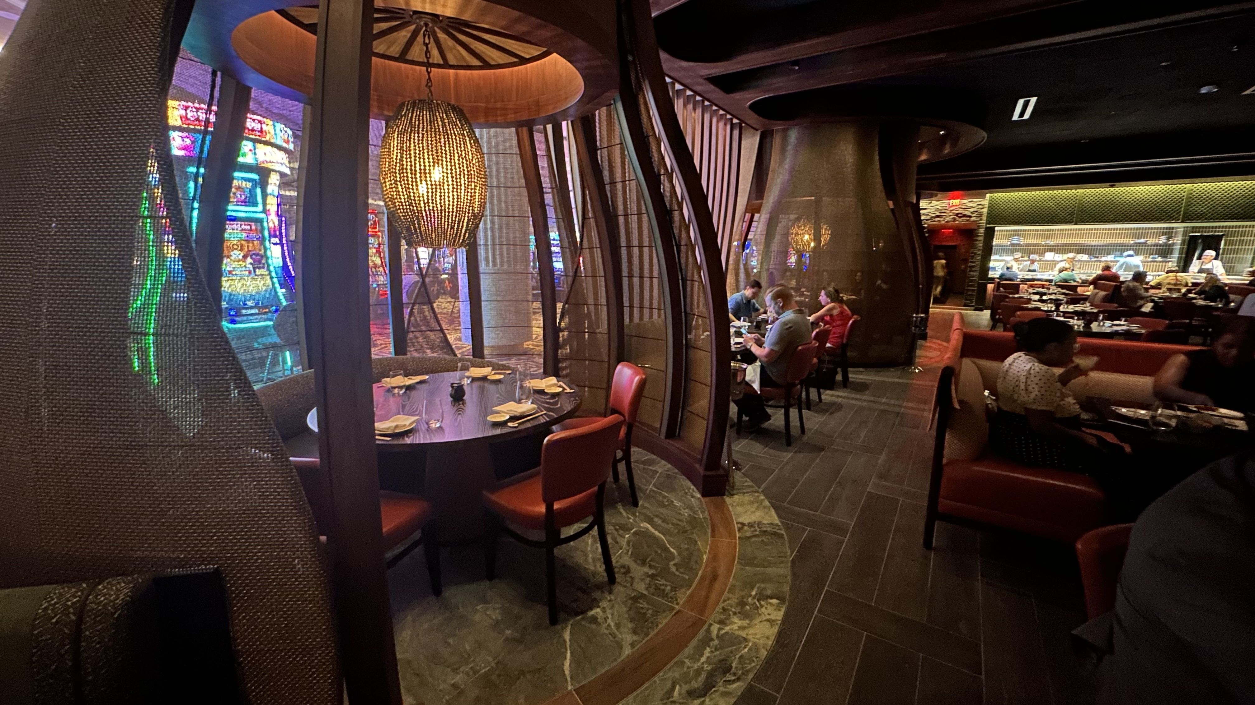 A basket-shaped design encircles a dining table.