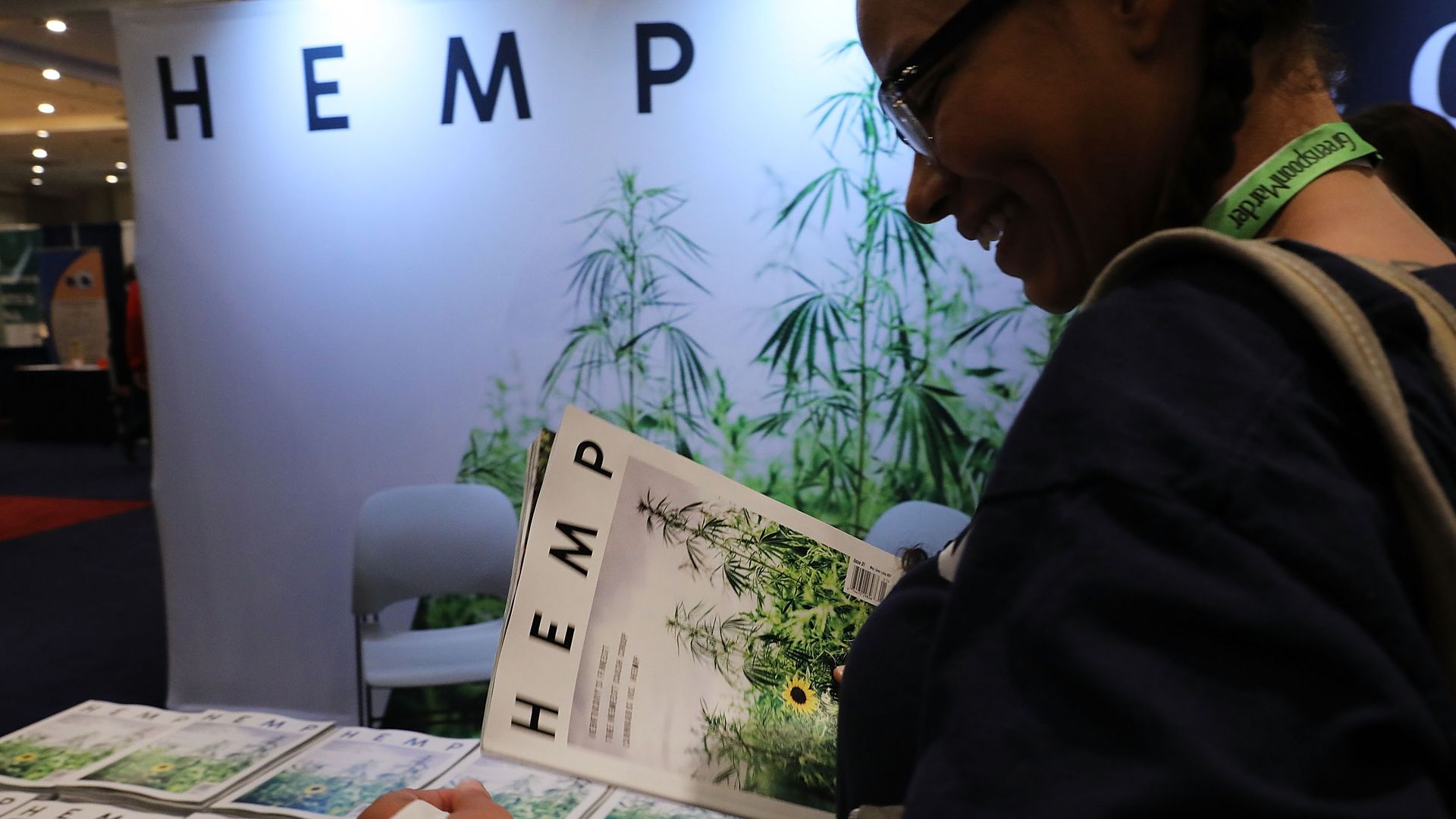 Signs and someone holding a magazine that says "hemp" on it