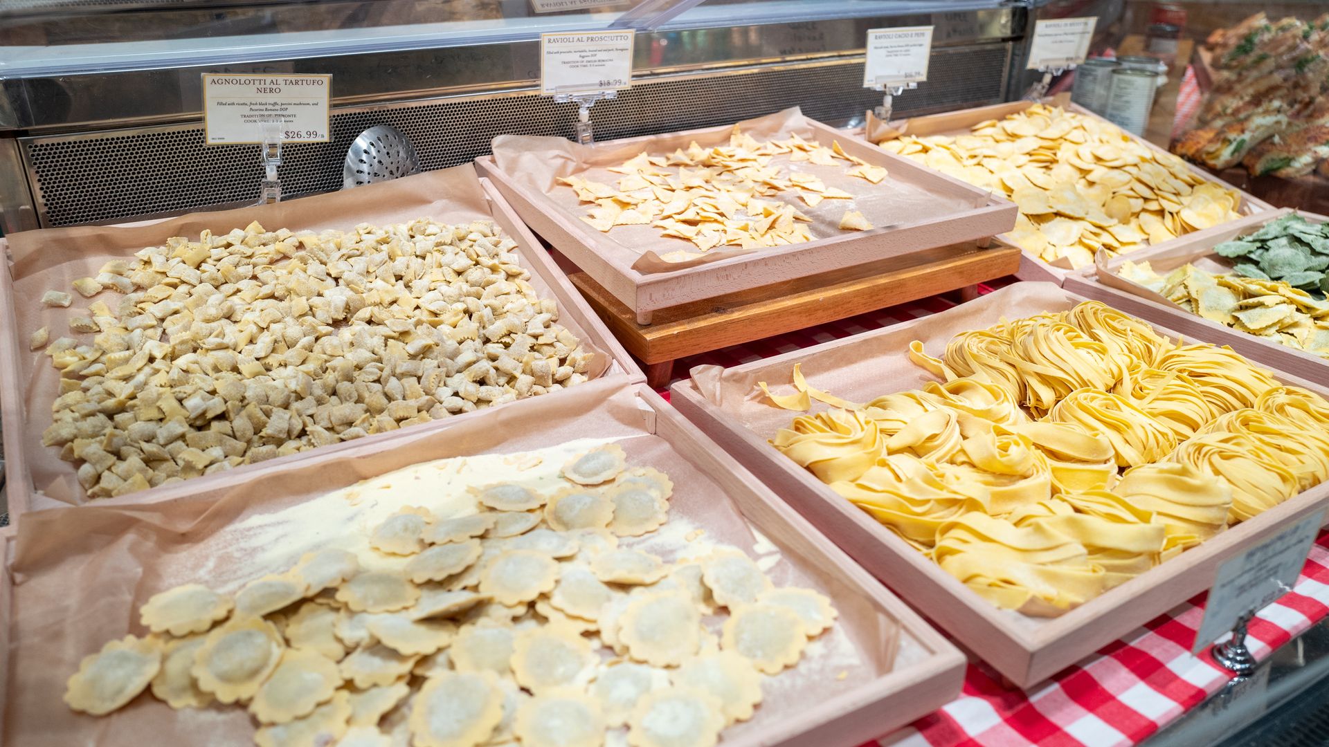 Various handmade fresh pasta noodles are on display at Eataly