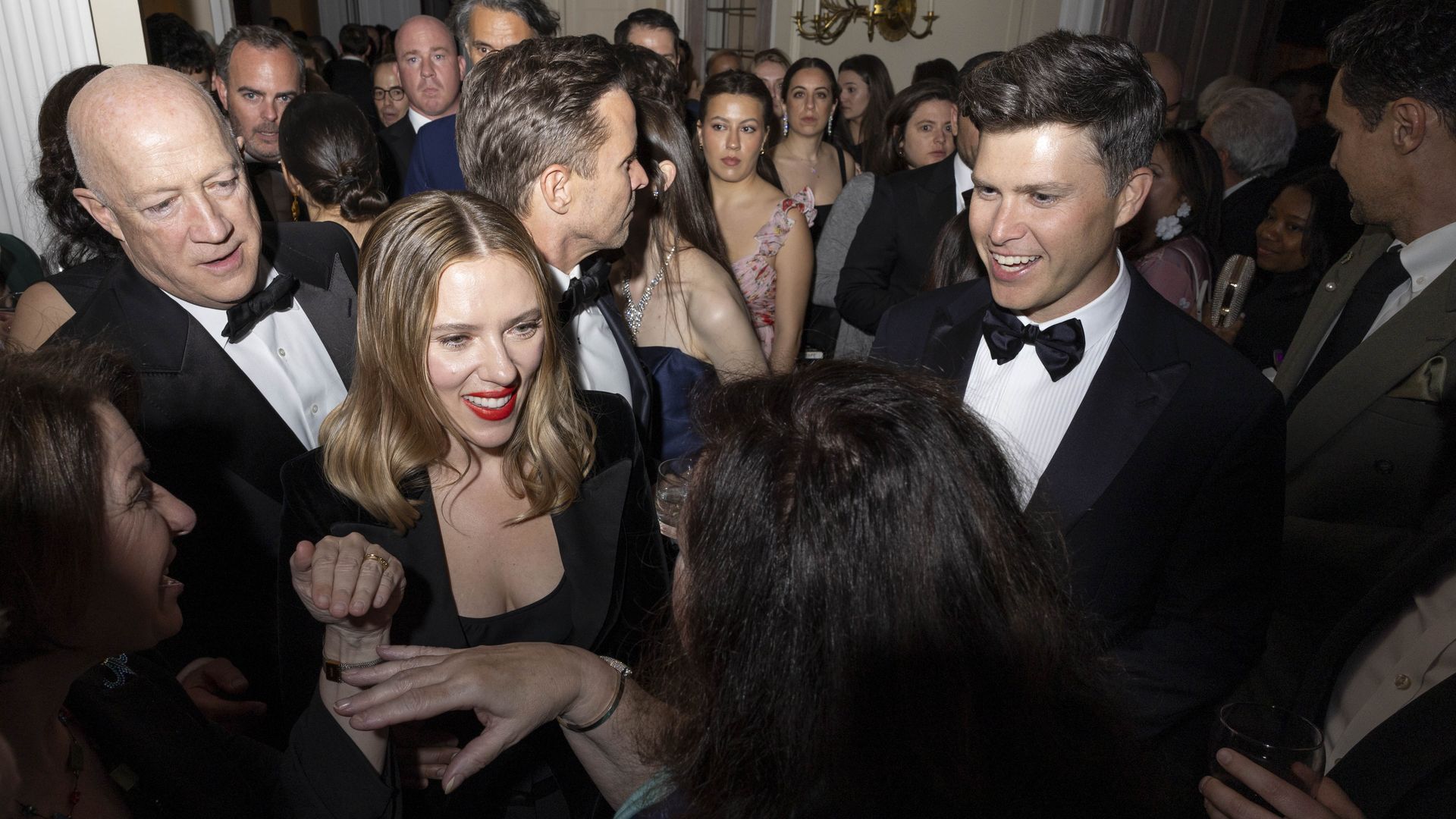 Photo of Scarlett Johansson in a black dress with others at a party