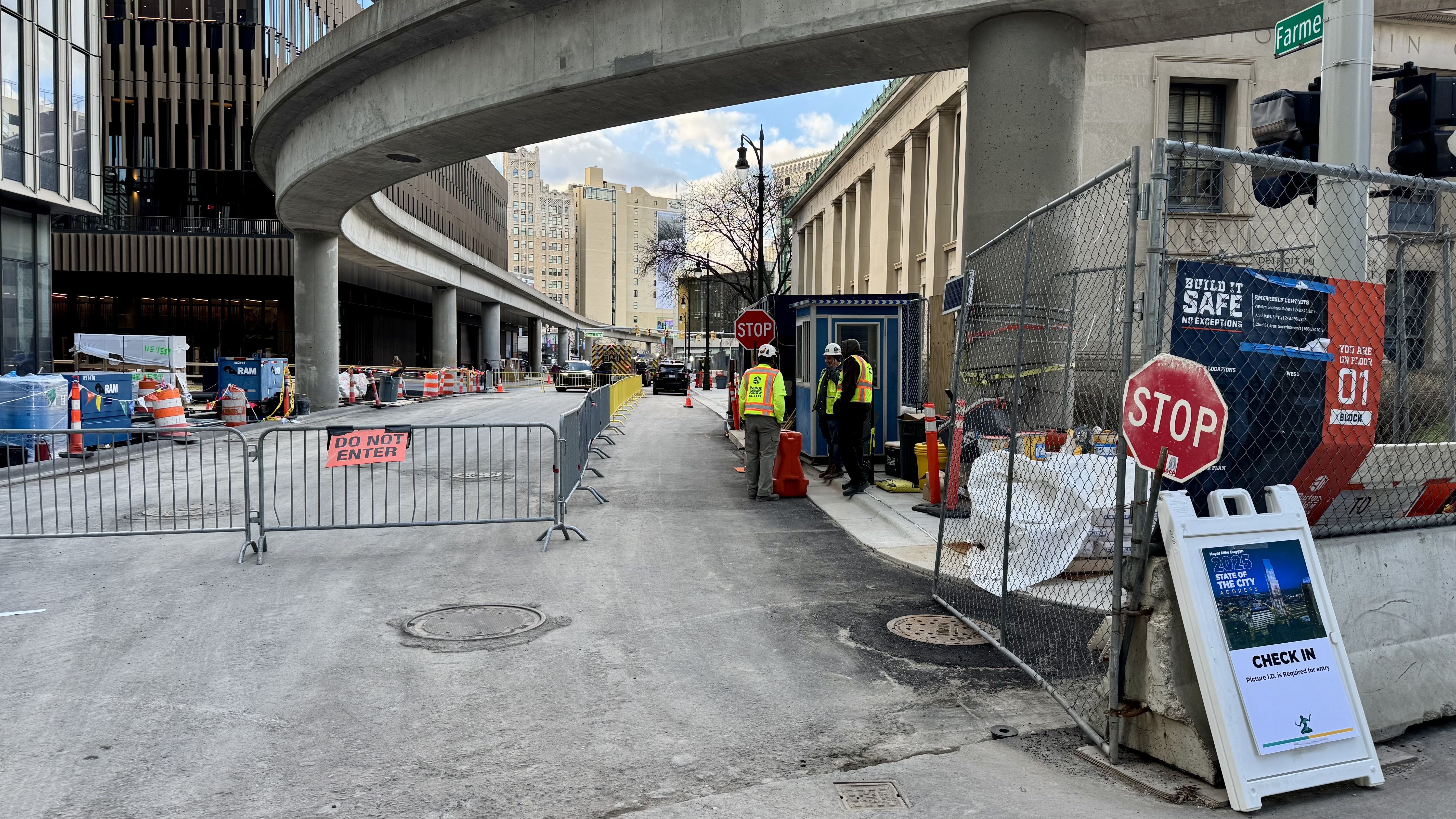 the entrance used to get into the building with construction workers in orange vests