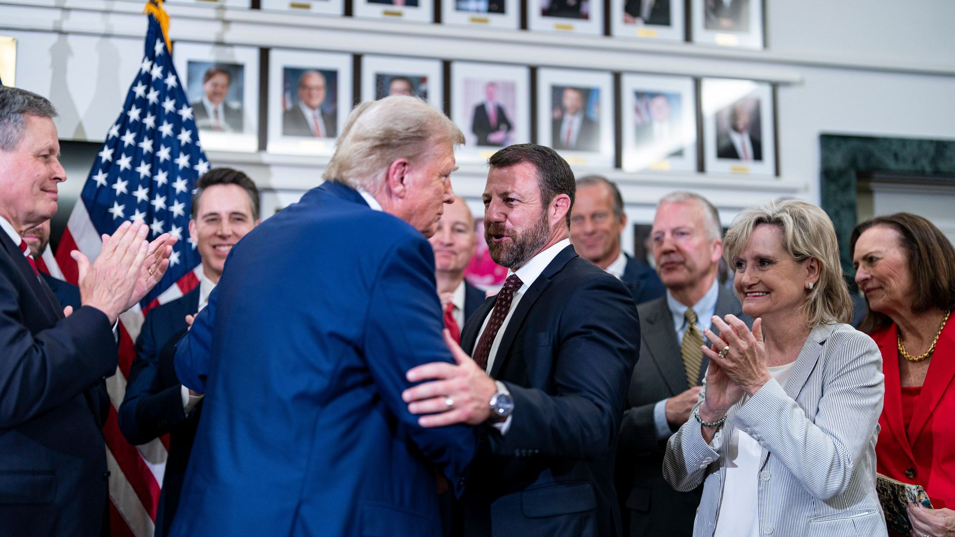 Former US President Donald Trump, center left, greets Senator Markwayne Mullin, a Republican from Oklahoma
