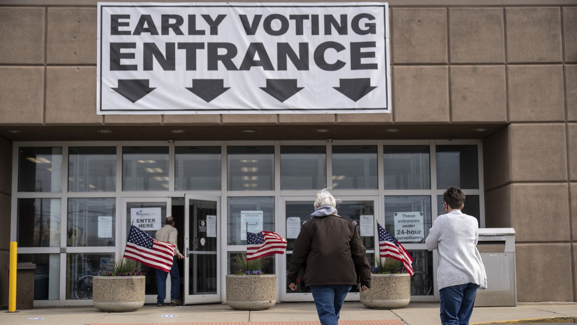 Two voters head toward the Franklin County Board of Elections for early voting.