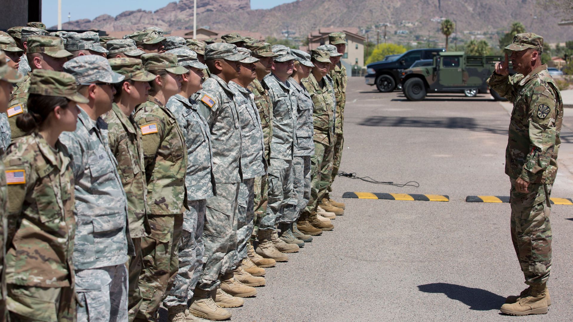 Members of the Arizona National Guard listen to instructions on April 9, 2018, at the Papago Park Military Reservation in Phoenix.
