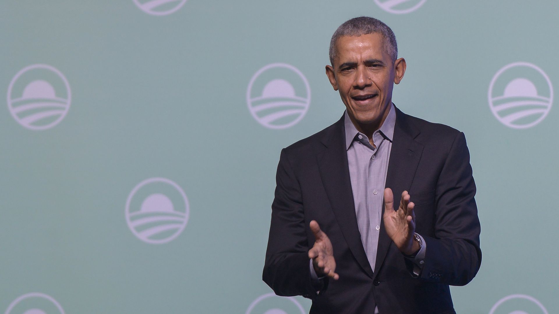 Former U.S. President Barack Obama gesture on the stage as he attends an Obama Foundation event