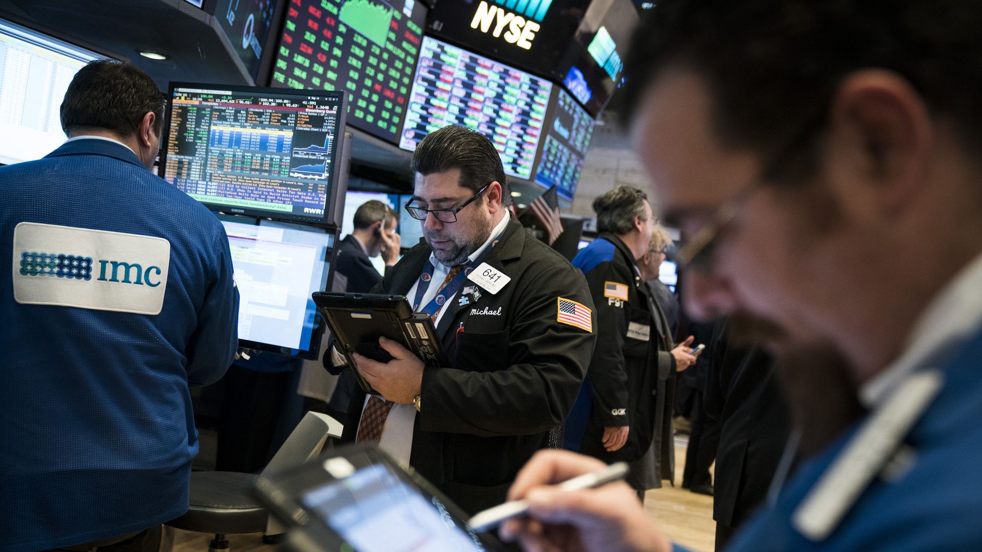 Traders and financial professional work ahead of the closing bell on the floor of the New York Stock Exchange