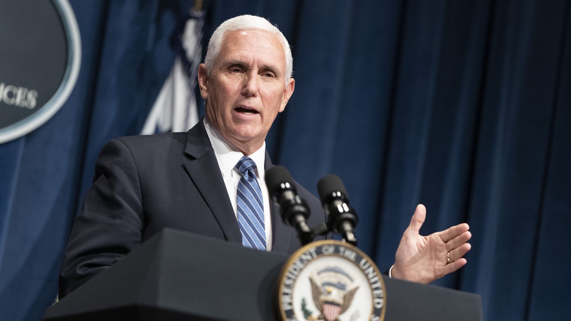 Vice President Mike Pence speaking at the podium during a press conference