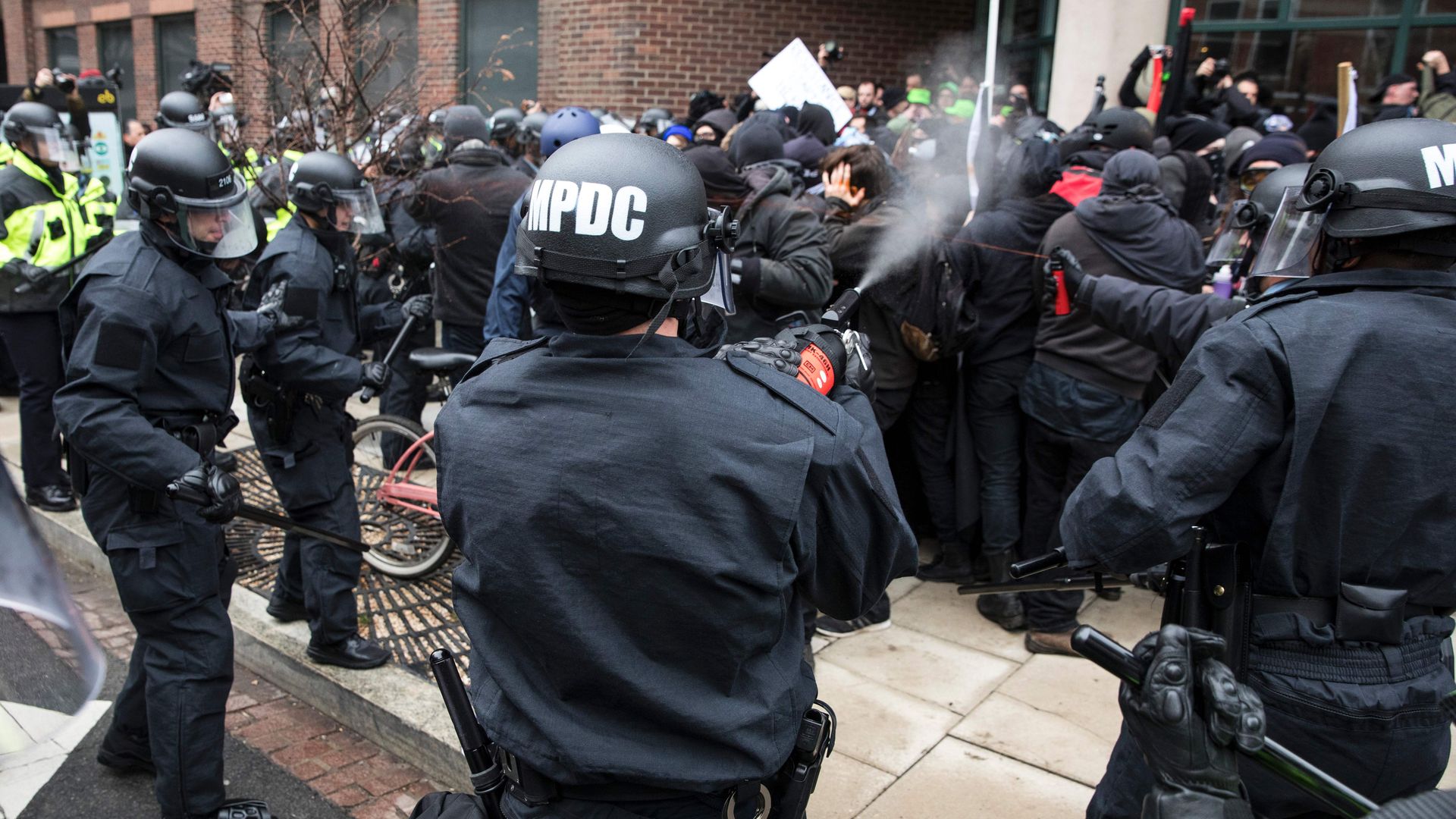 Police officers pepper spray a group of protestors before the inauguration of President-elect Donald Trump January 20, 2017 in Washington, DC. 