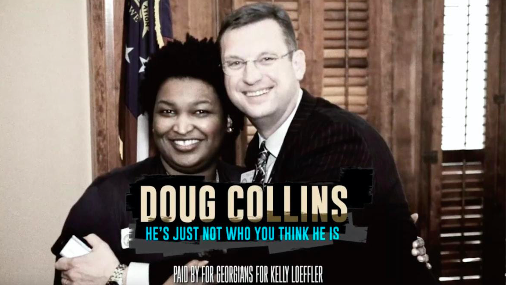 A screenshot of Kelly Loeffler's campaign ad showing Doug Collins hugging Stacey Abrams